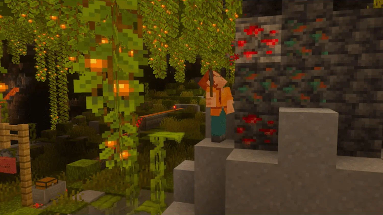 Un personnage de Minecraft regarde un minerai rouge dans une grotte verte avec des baies.
