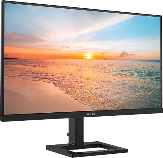 Egy vékony keretes Philips monitor színes naplementét mutat egy homokos tengerparton.