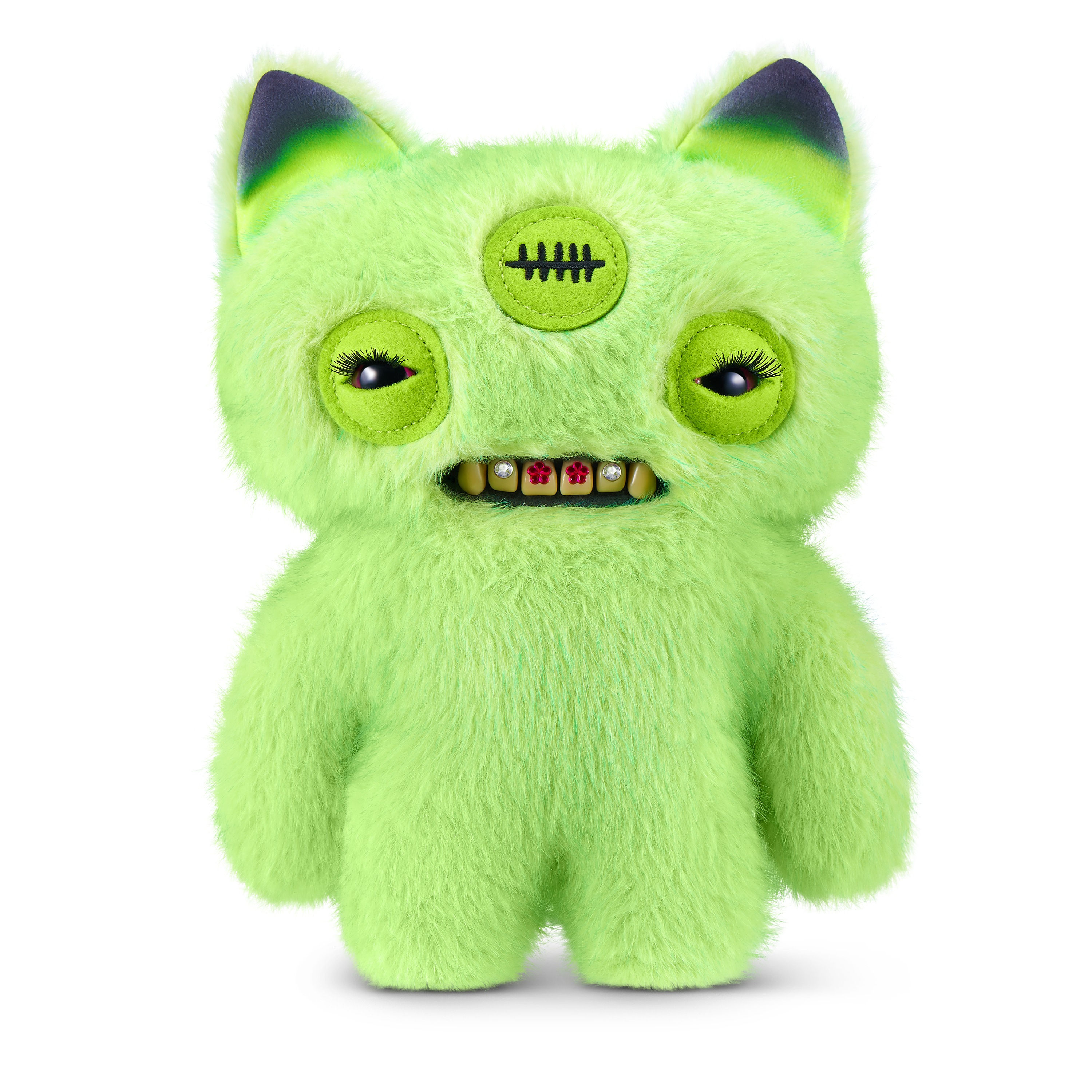 Un monstruo de peluche verde brillante con tres ojos, dientes con joyas y orejas negras sobre fondo blanco.