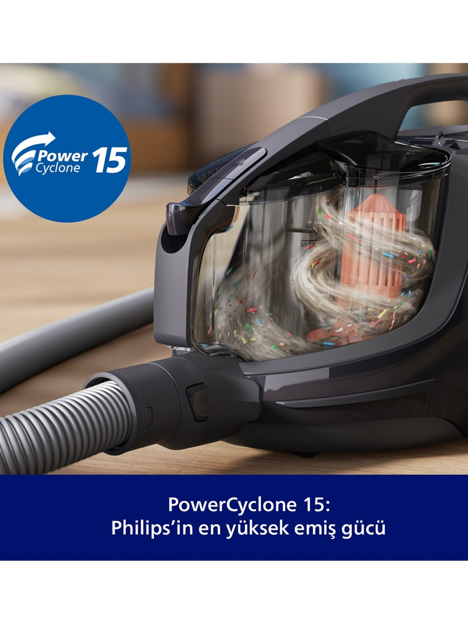 Şeffaf toz haznesinde kir ve renkli parçacıkların döndüğü siyah Philips elektrikli süpürge.
