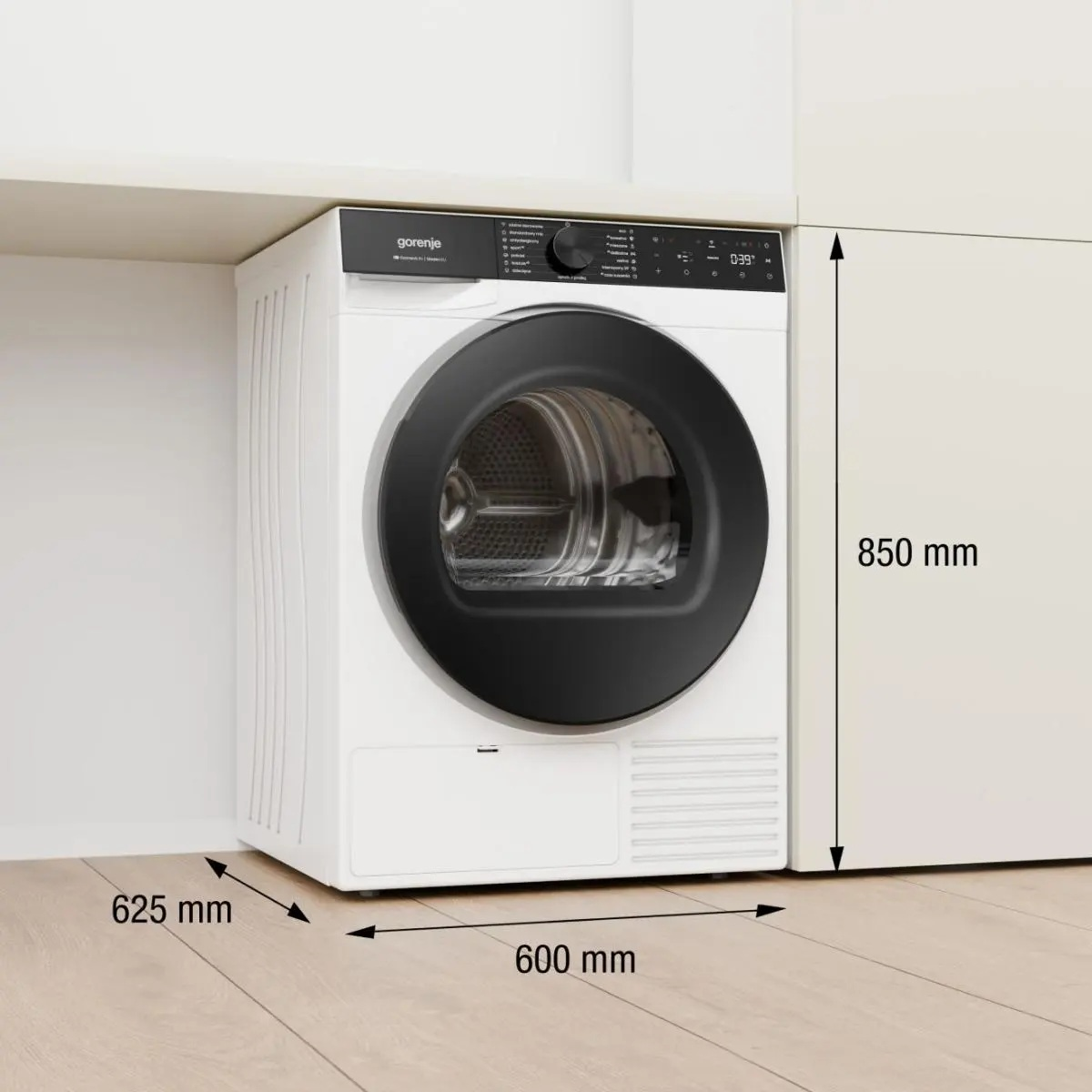 Biała suszarka Gorenje we wnęce o wymiarach 850x600x625 mm na drewnianej podłodze.