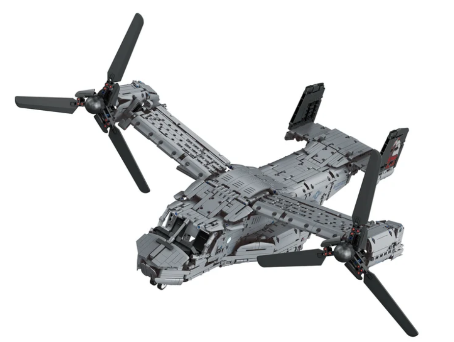 Ein graues Spielzeugflugzeug mit großen Rotorblättern an den Flügelenden auf weißem Hintergrund.