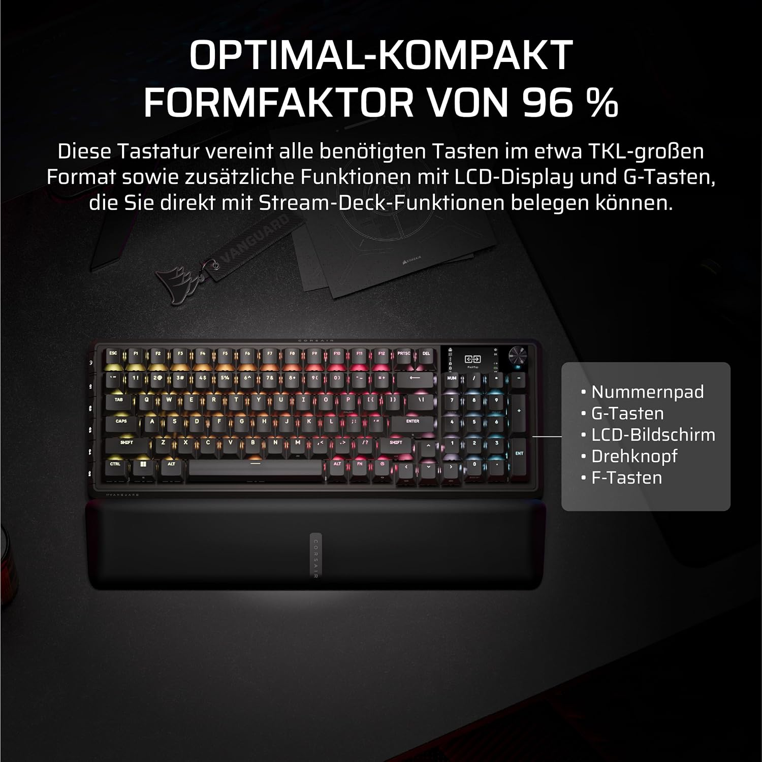 96%-Tastatur mit LCD-Display, G-Tasten, Nummernblock und Handballenauflage auf dunklem Tisch.