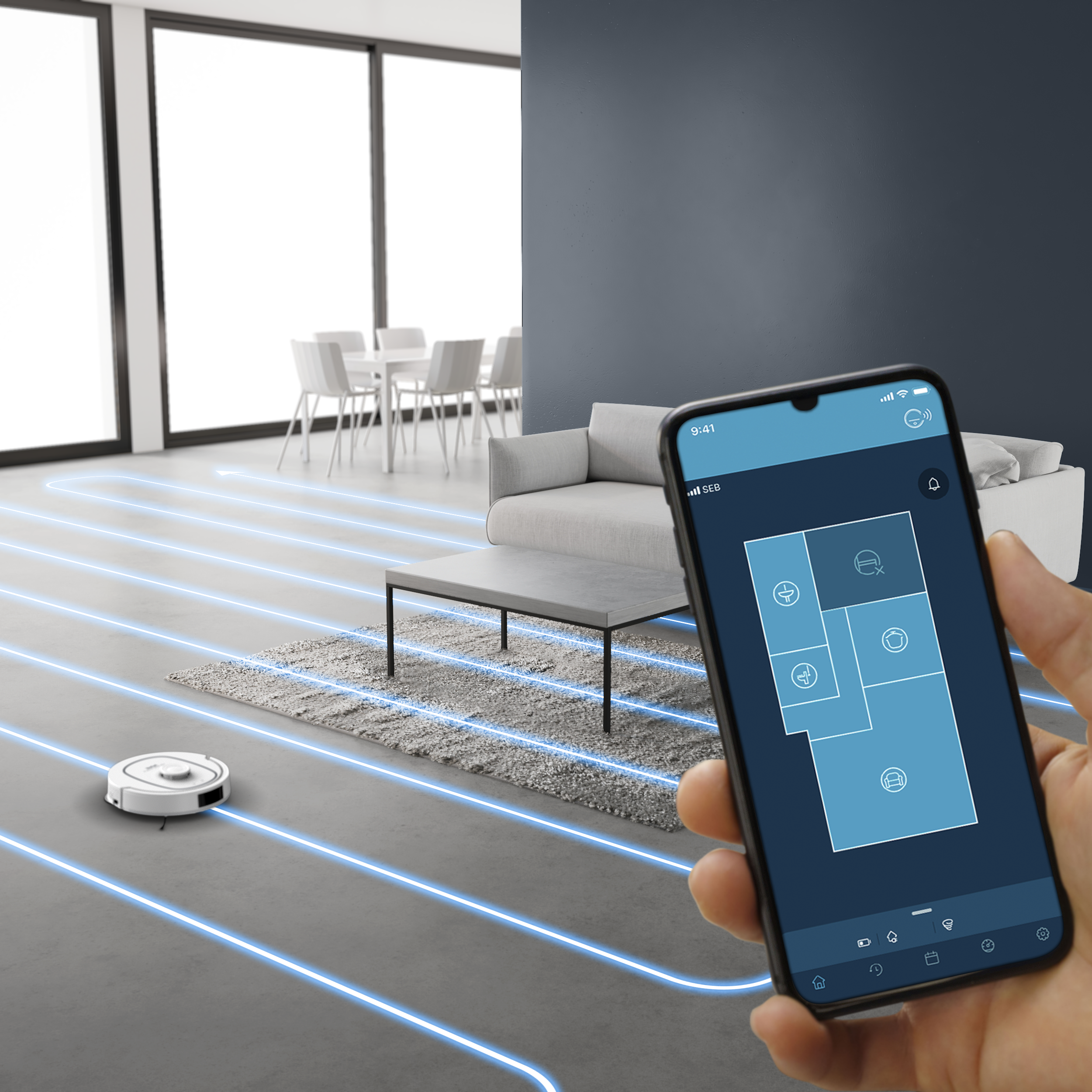 Egy okostelefon takarítási alkalmazást mutat, miközben egy robotporszívó egy modern nappalit takarít.