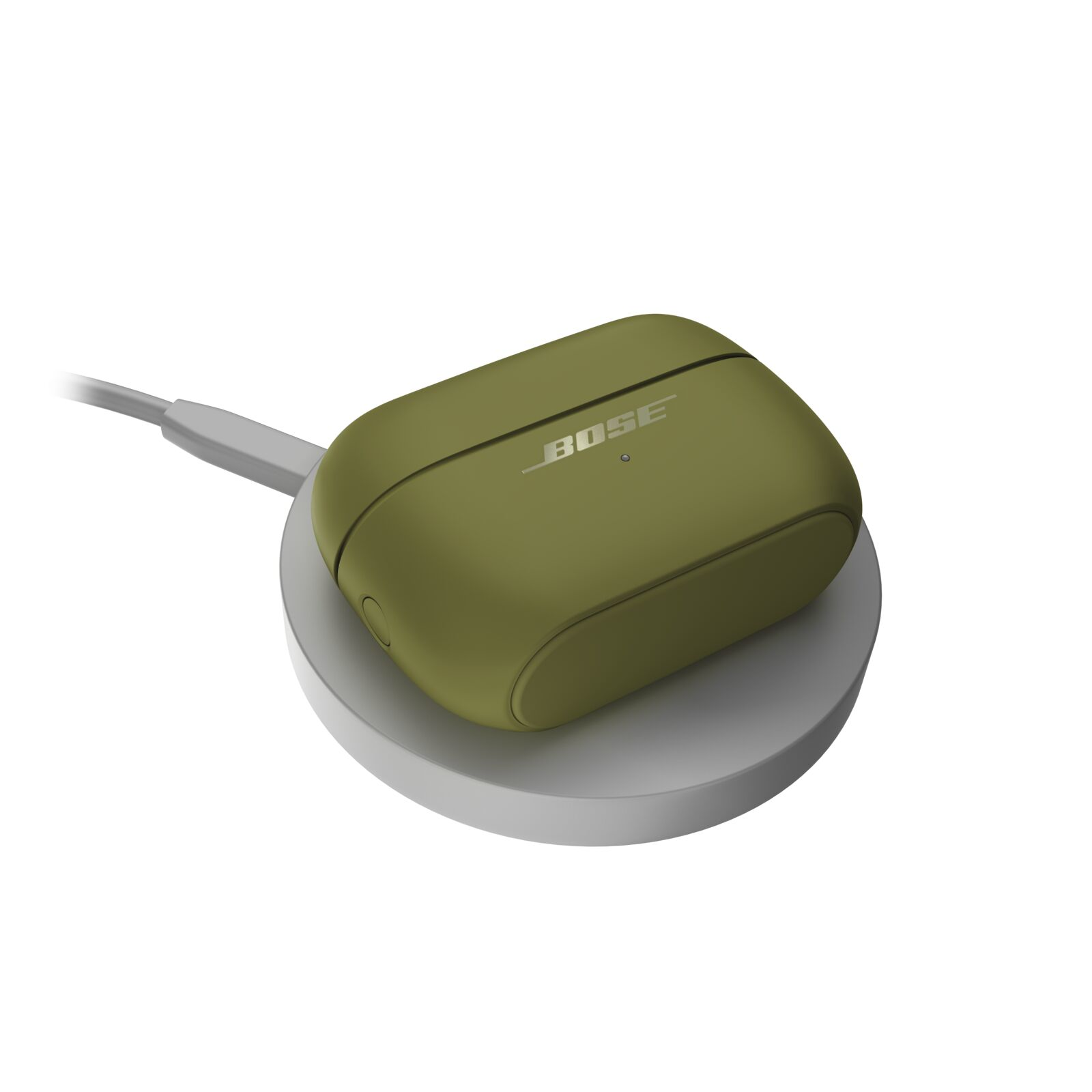 Ein olivgrünes Bose-In-Ear-Kopfhörer-Ladecase lädt auf einem runden grauen Pad vor weißem Hintergrund.