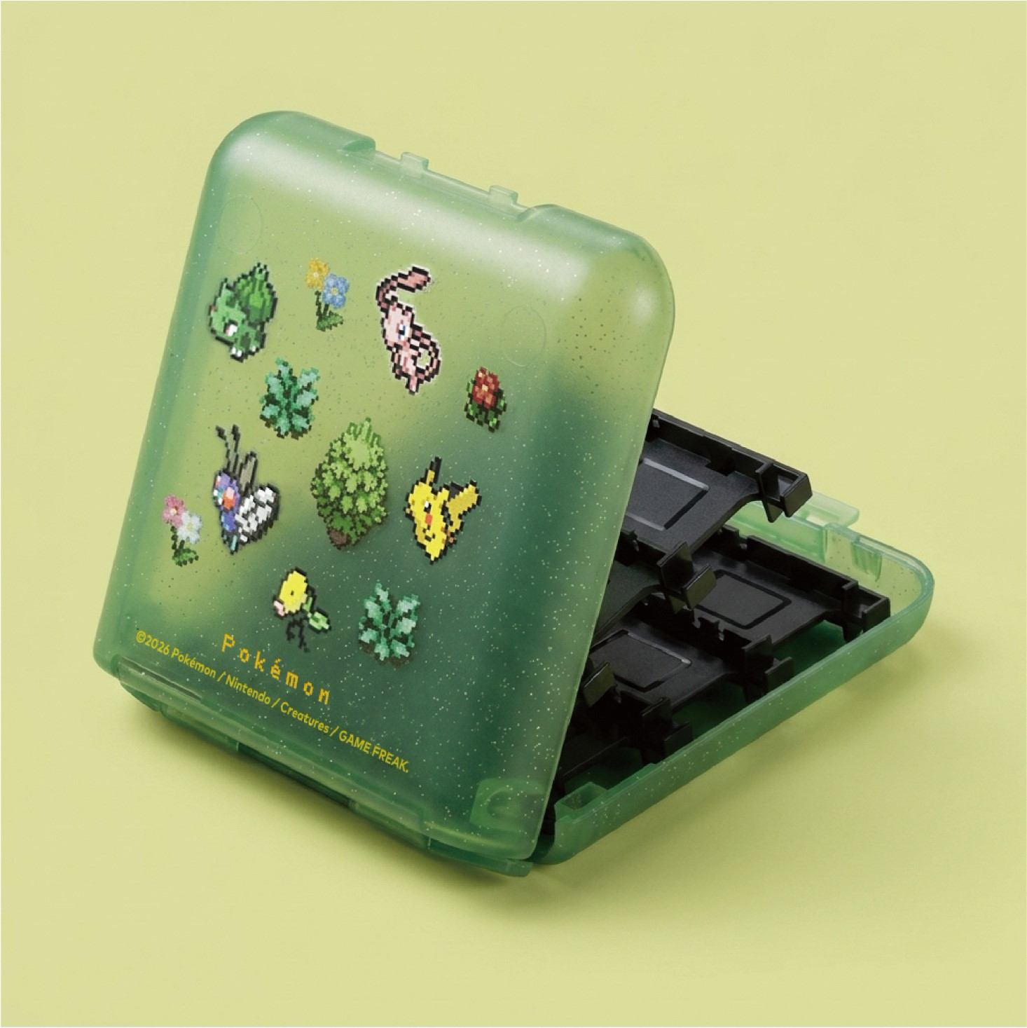 Custodia per cartucce di gioco Pokémon verde traslucido con pixel art e interno nero.