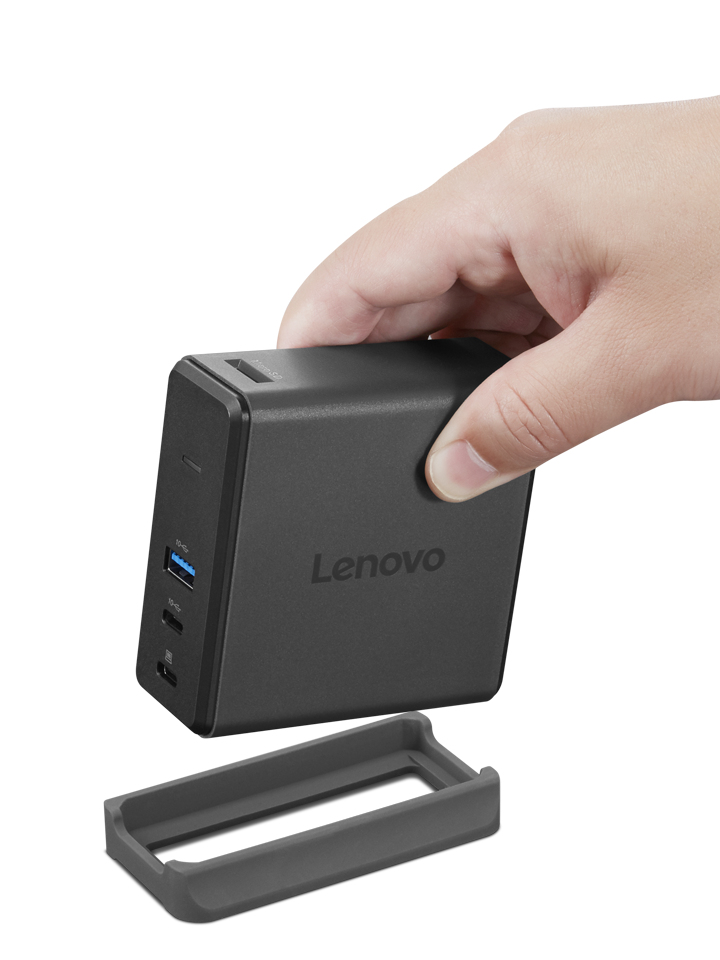 Mano sosteniendo la estación de acoplamiento Lenovo gris sobre su soporte.