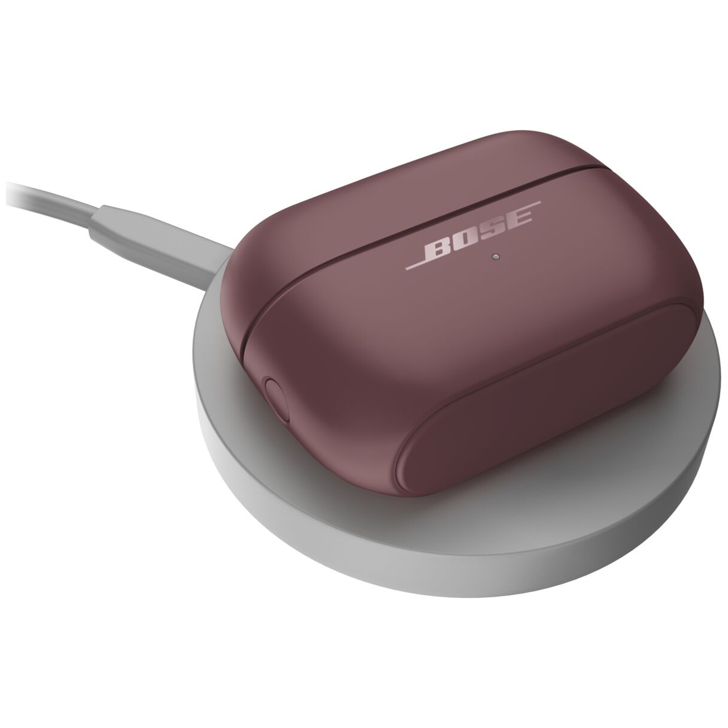 Een paarse Bose-oplaadcase rust op een ronde, grijze draadloze oplader met een aangesloten kabel.