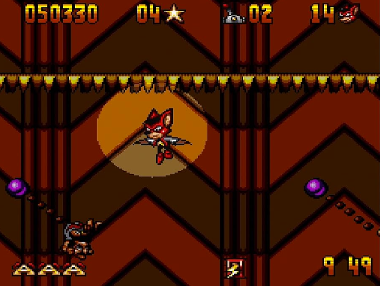 Eine 2D-Plattformspielszene zeigt einen rot-schwarzen Charakter, der im Rampenlicht vor braunem Hintergrund fliegt.