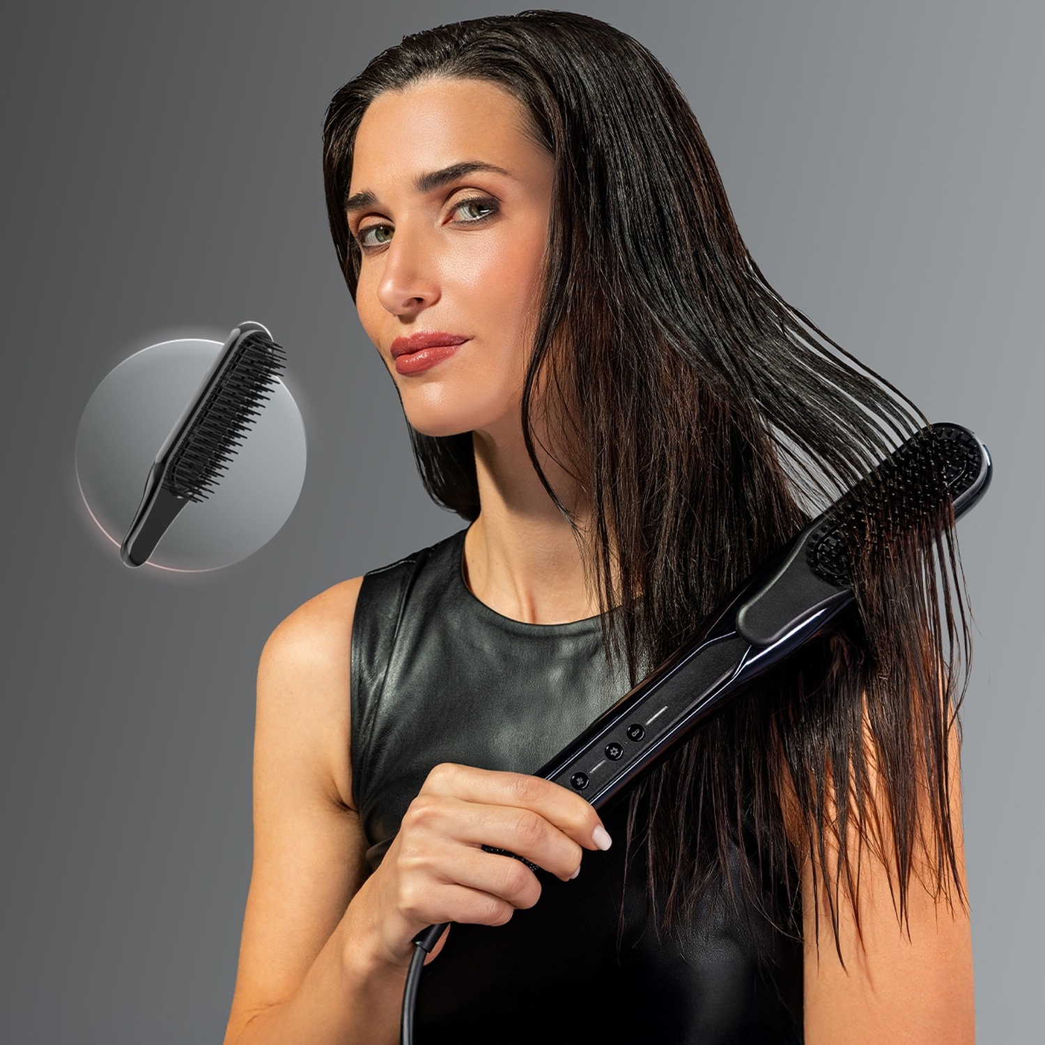 Una donna con i capelli scuri bagnati tiene in mano una spazzola lisciante nera.