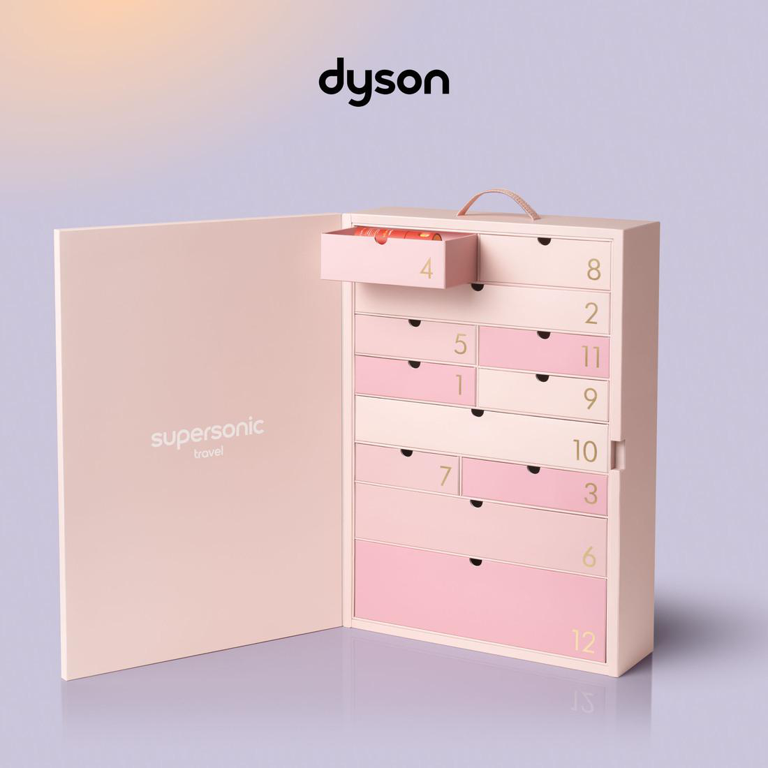 Rosa Dyson Adventskalender mit durchnummerierten Schubladen vor lila Hintergrund.