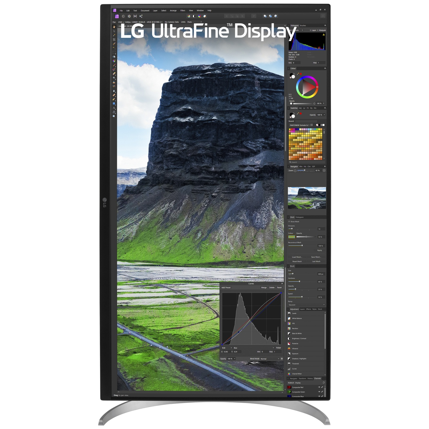 LG UltraFine display showing a vertical landscape photo and design software interface.