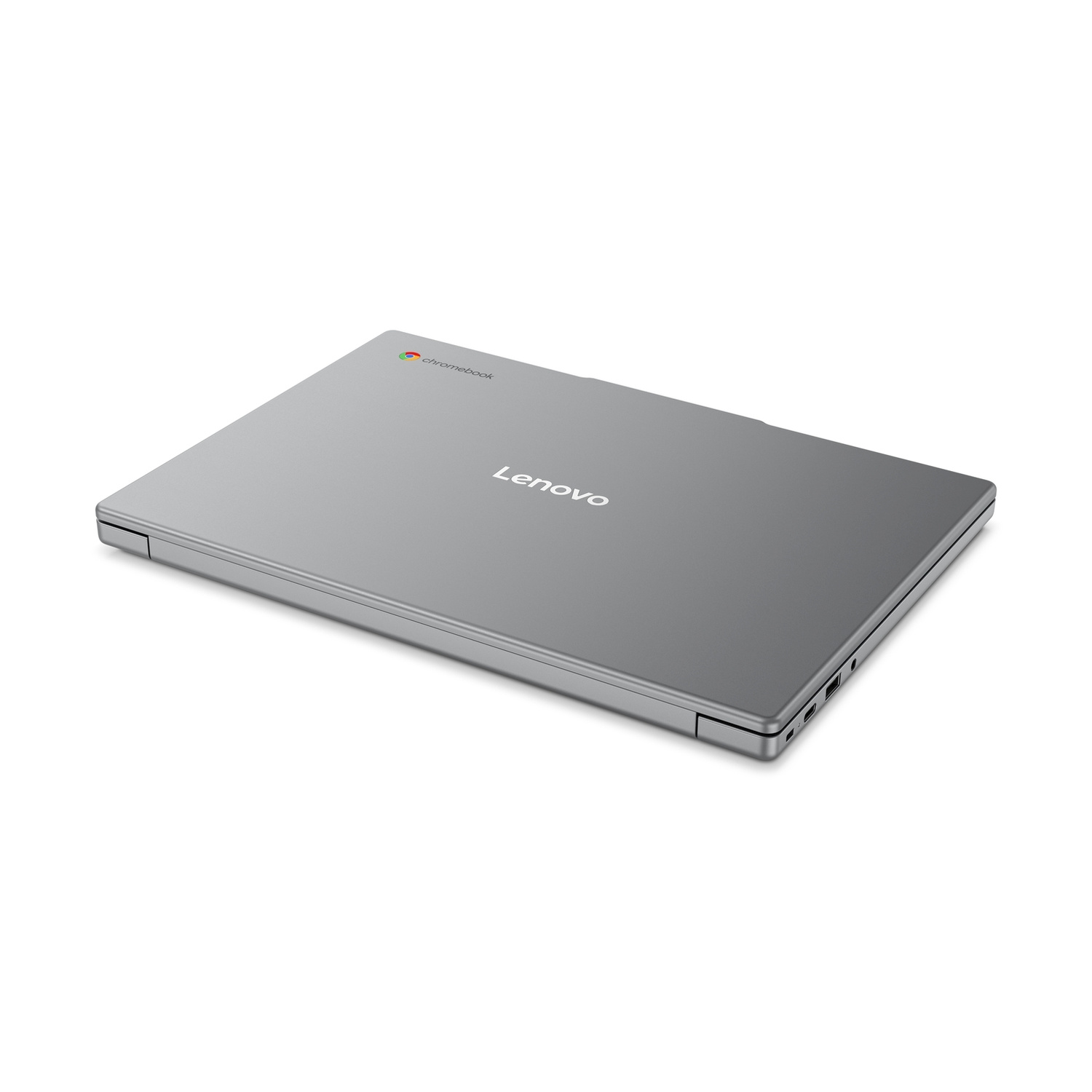 Un computer portatile Lenovo Chromebook grigio chiuso poggia su una superficie bianca.