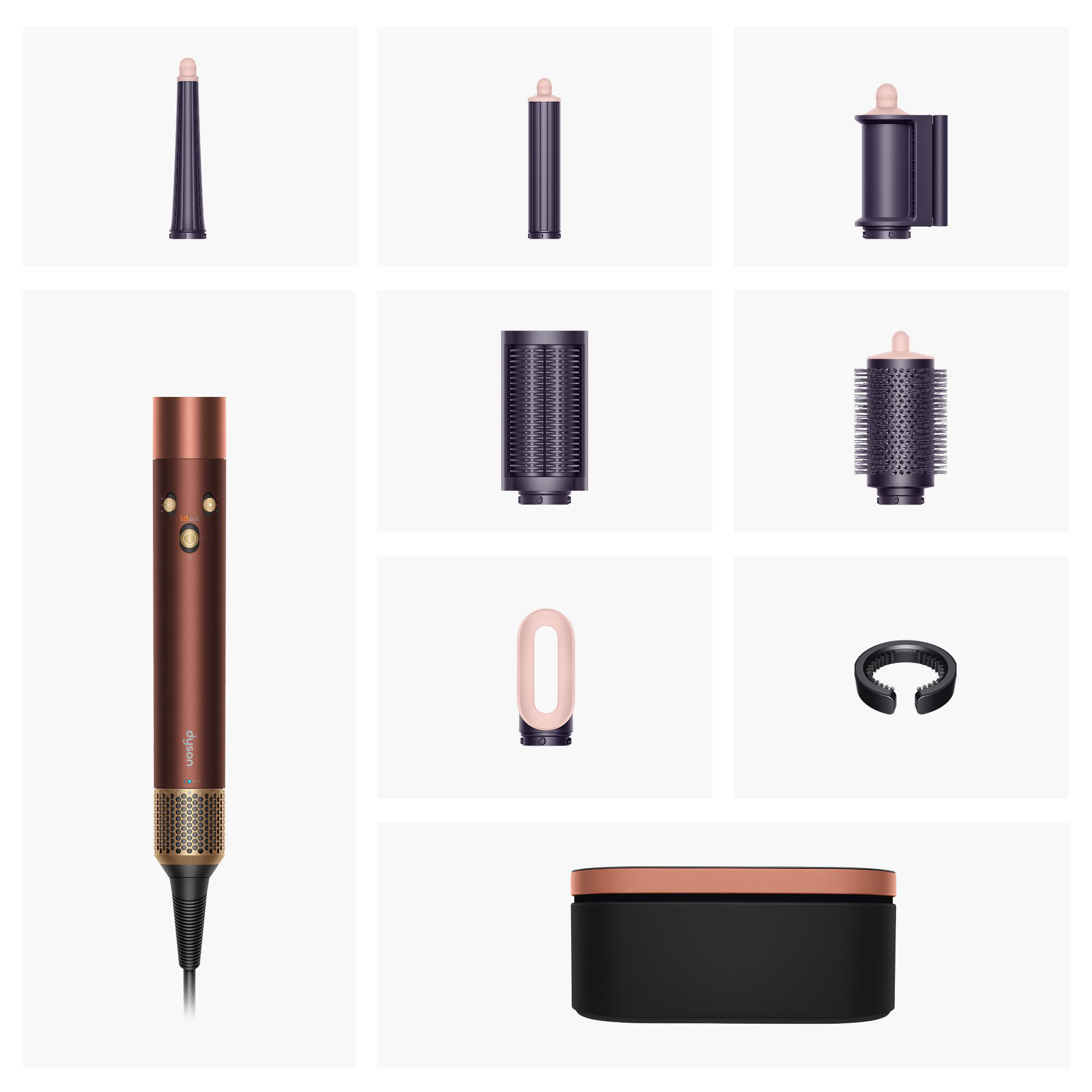 Dyson Haarstyler in Kuper und Braun mit verschiedenen Aufsätzen und Aufbewahrungsbox auf hellem Hintergrund.