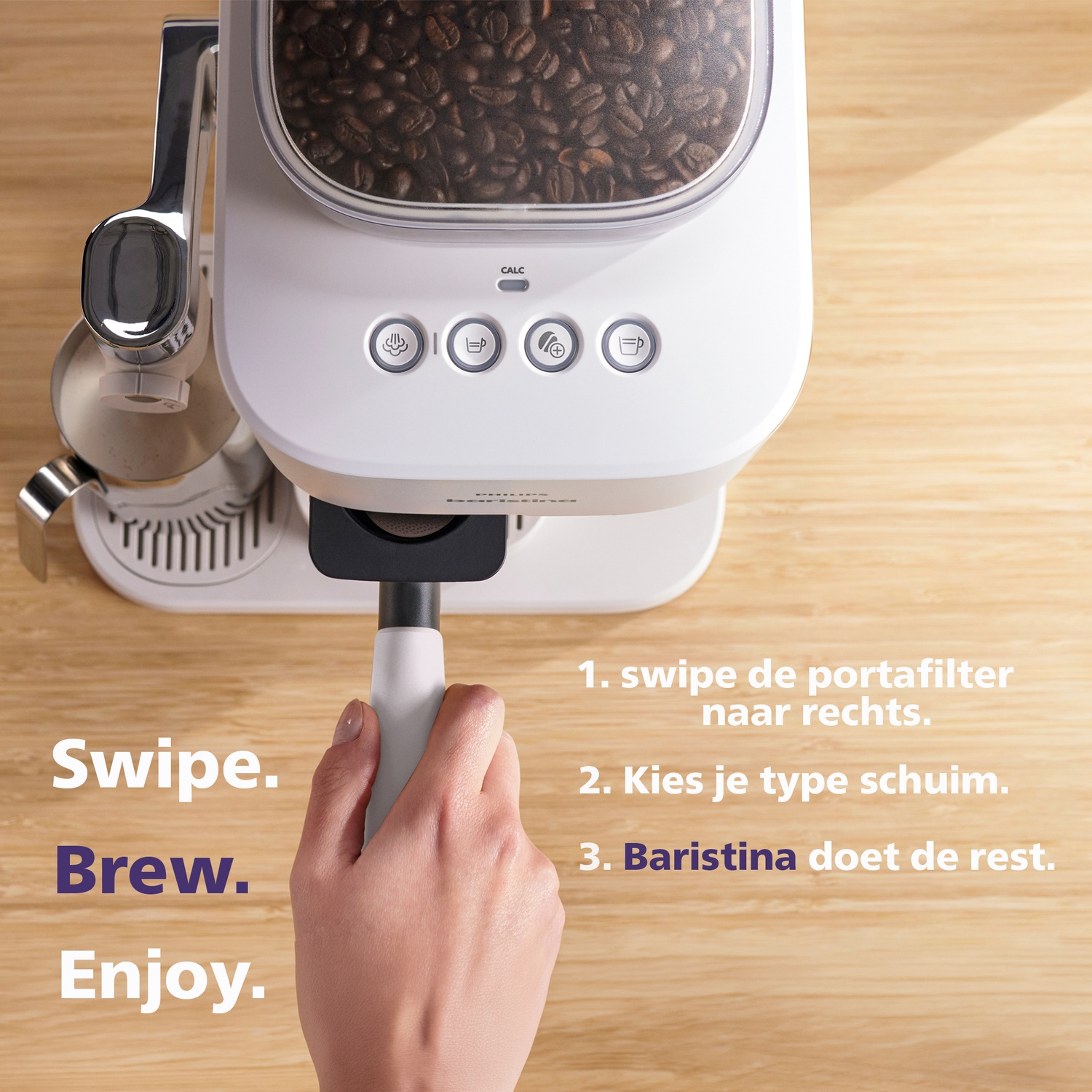 A hand holding the portafilter of a white coffee machine on a wooden table with text overlay.