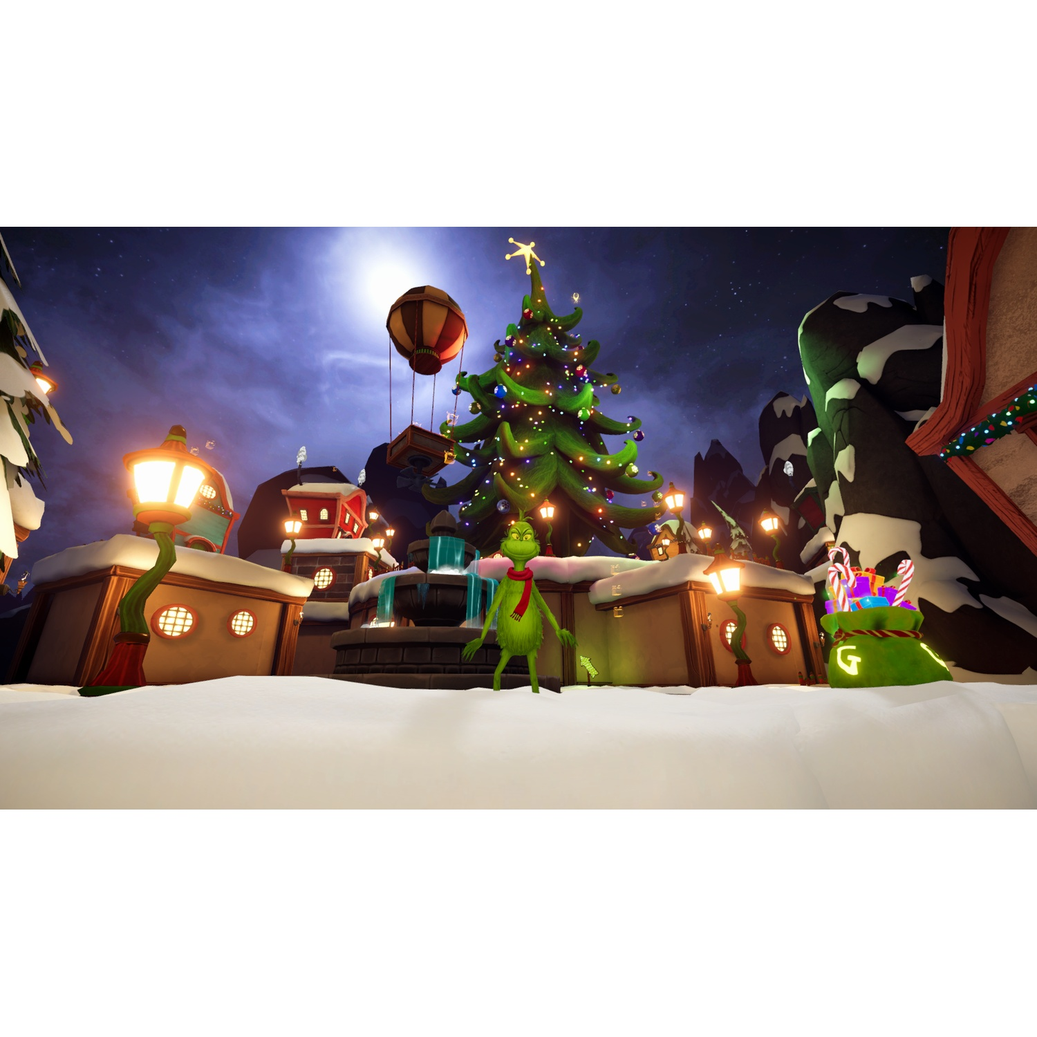 The Grinch stands in a snowy village with a large Christmas tree and glowing lanterns at night.
