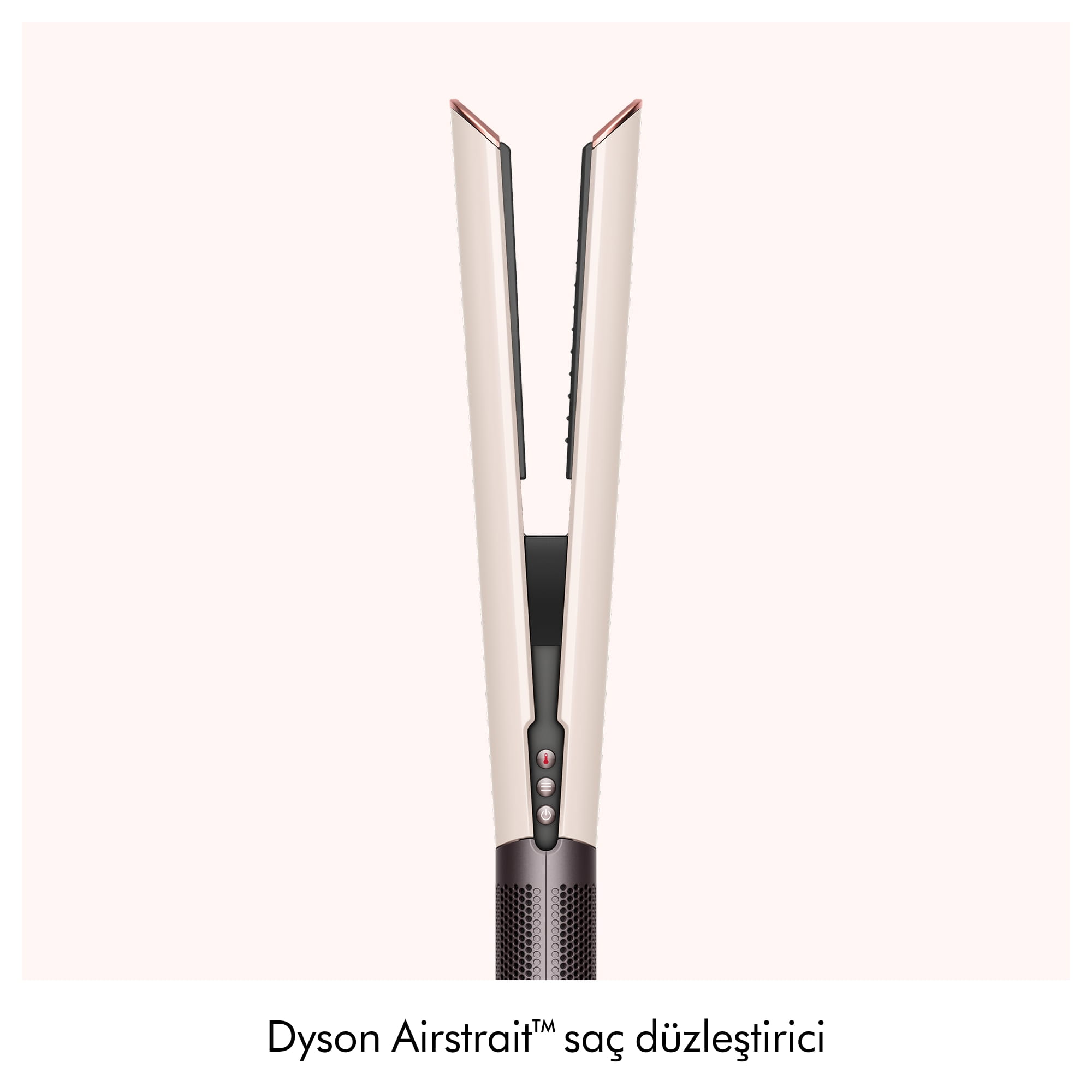 Açık arka plan önünde bej ve pembe altın rengi Dyson Airstrait saç düzleştirici.