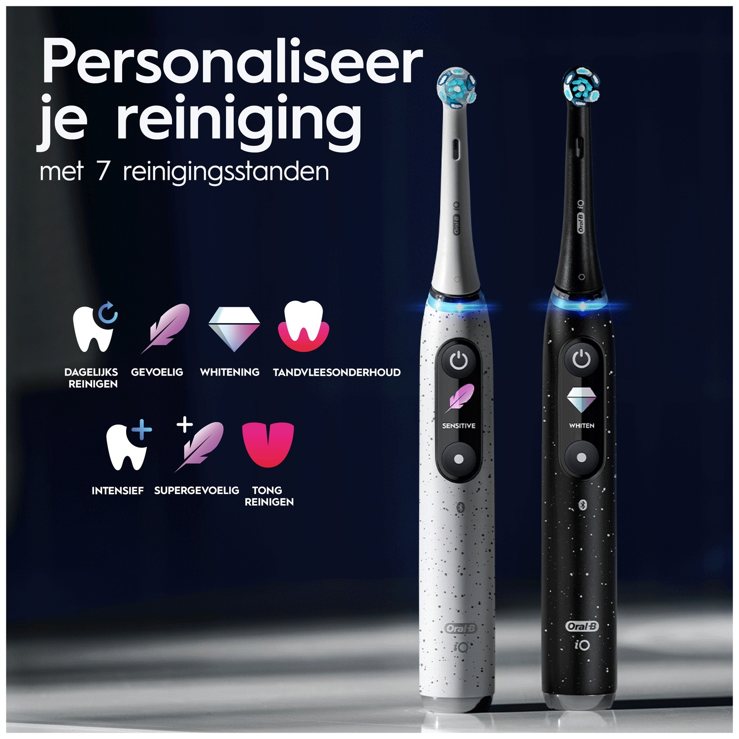 Two Oral-B iO electric toothbrushes in white and black stand upright against a dark background with Dutch text.