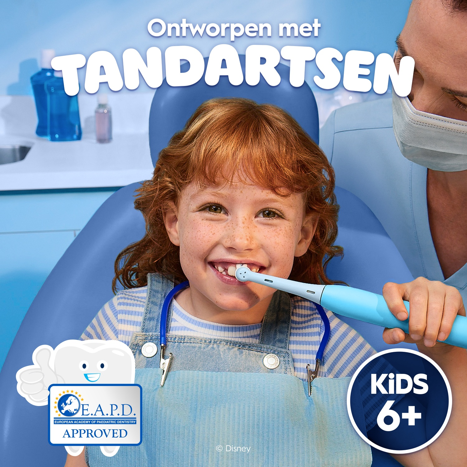 A red-haired girl brushes her teeth with an electric toothbrush in a dentist's chair.
