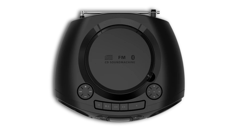 Un reproductor de CD negro con puerta redonda, radio FM y botones, visto desde arriba.