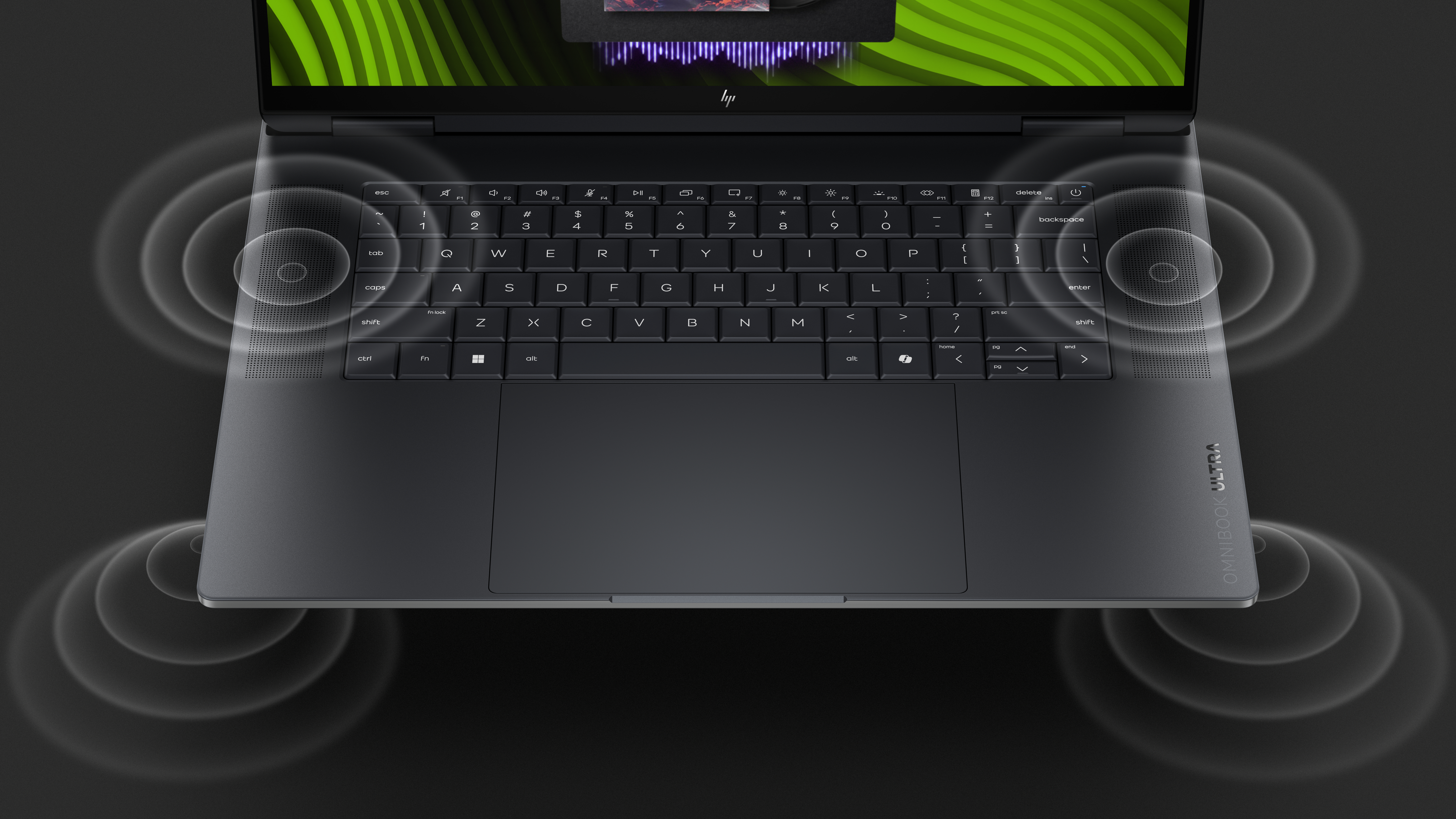 Draufsicht auf die Tastatur eines schwarzen Laptops mit Wellenmustern als Soundeffekt.