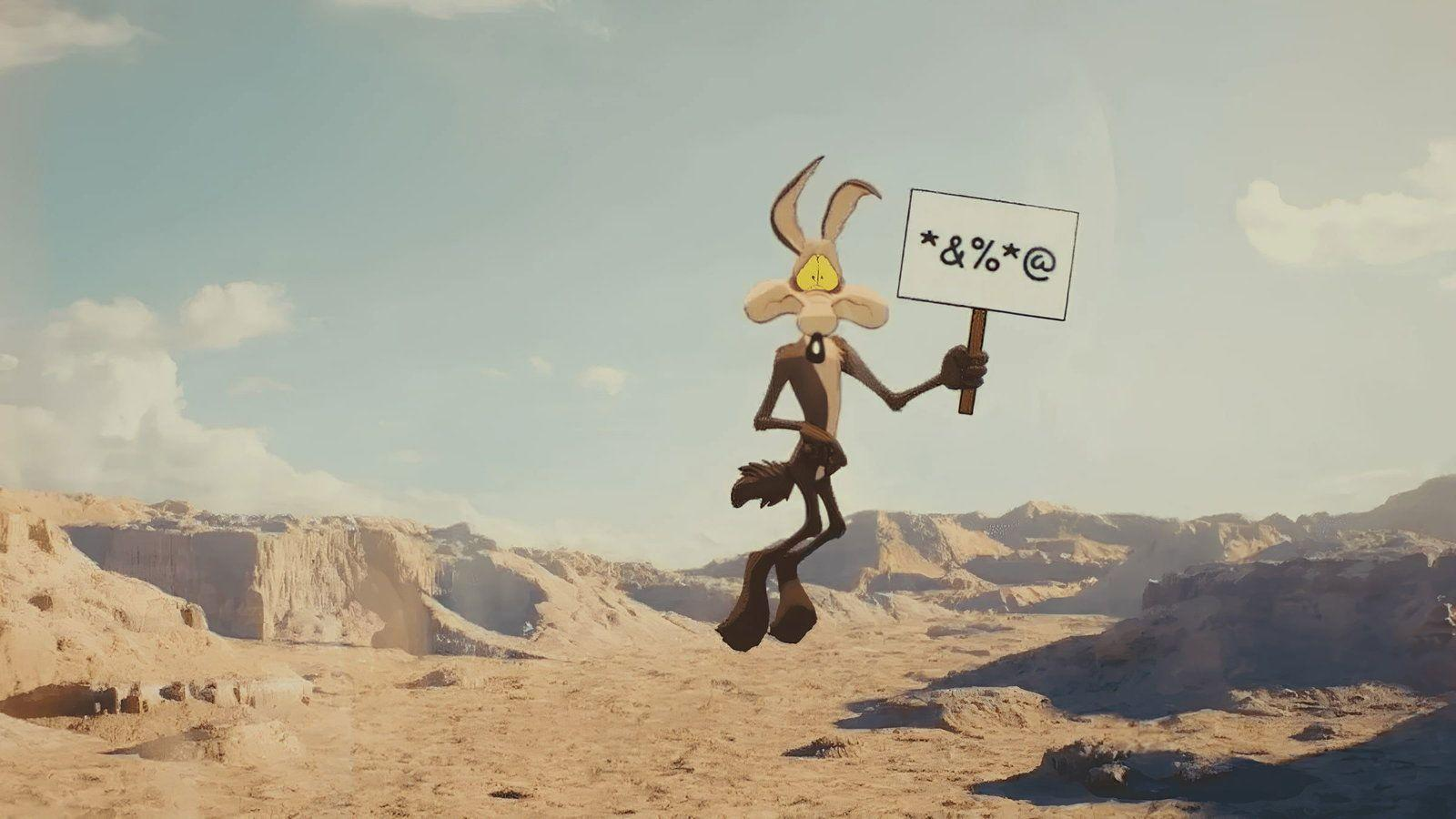 Wile E. Coyote schwebt in einer Wüstenlandschaft und hält ein Schild mit Symbolen.
