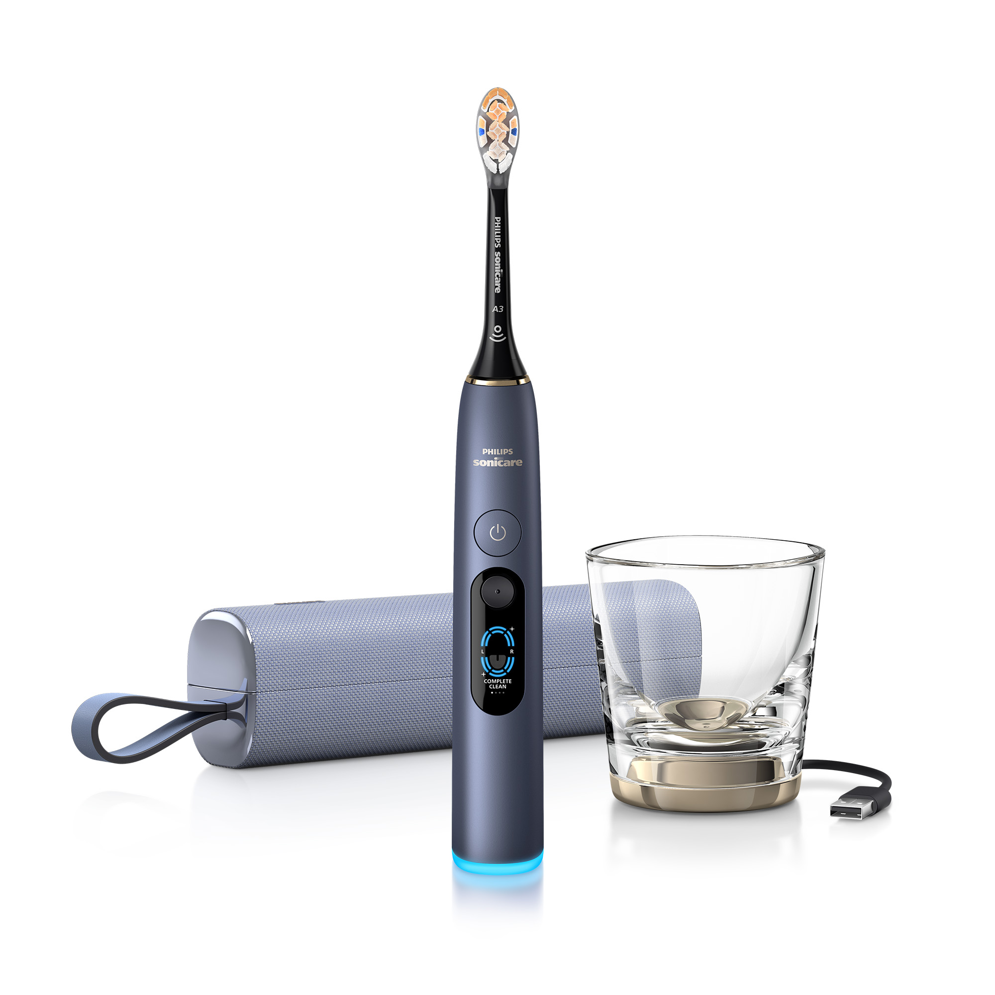 Cepillo de dientes azul Philips Sonicare con estuche, vaso y cable de carga sobre fondo blanco.