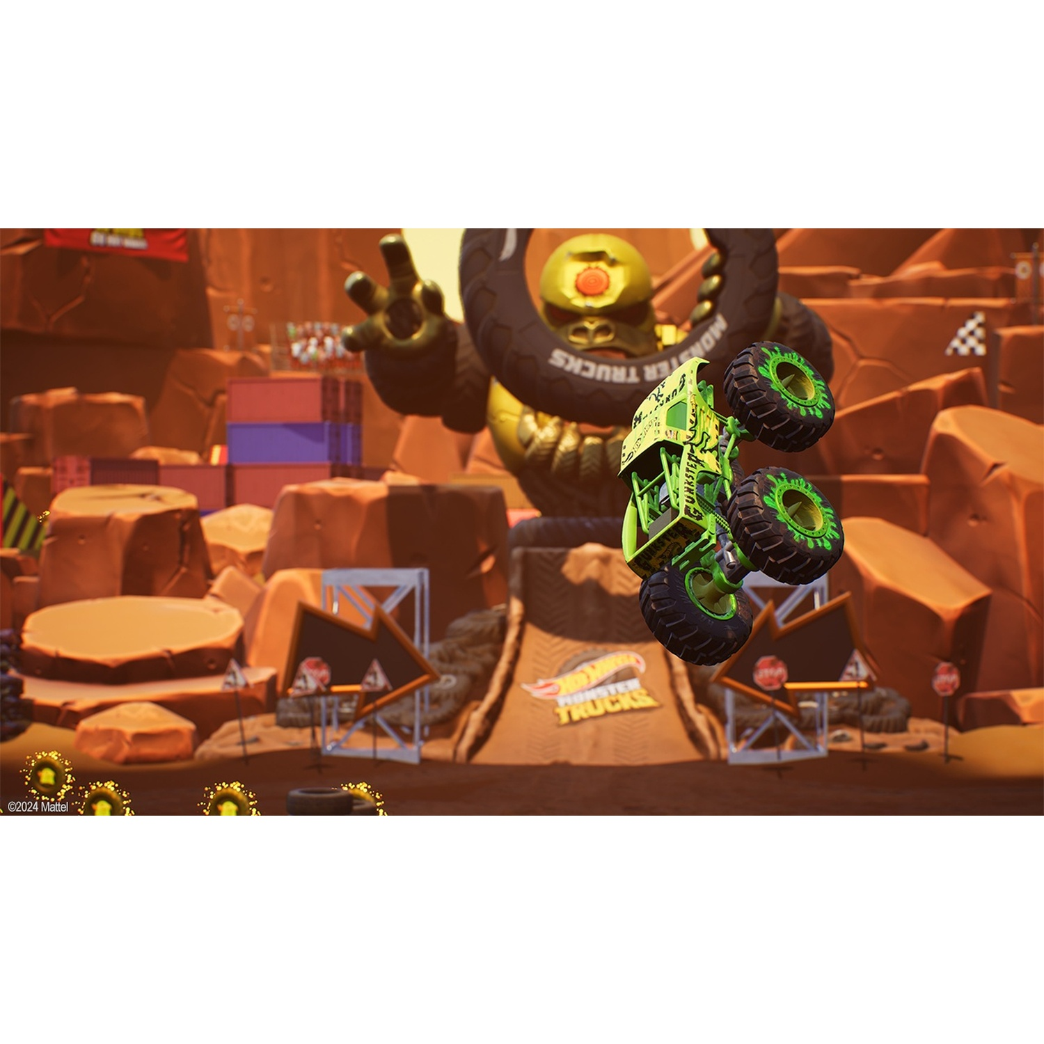 A green monster truck jumps in the air before a giant gorilla figure and a canyon landscape.