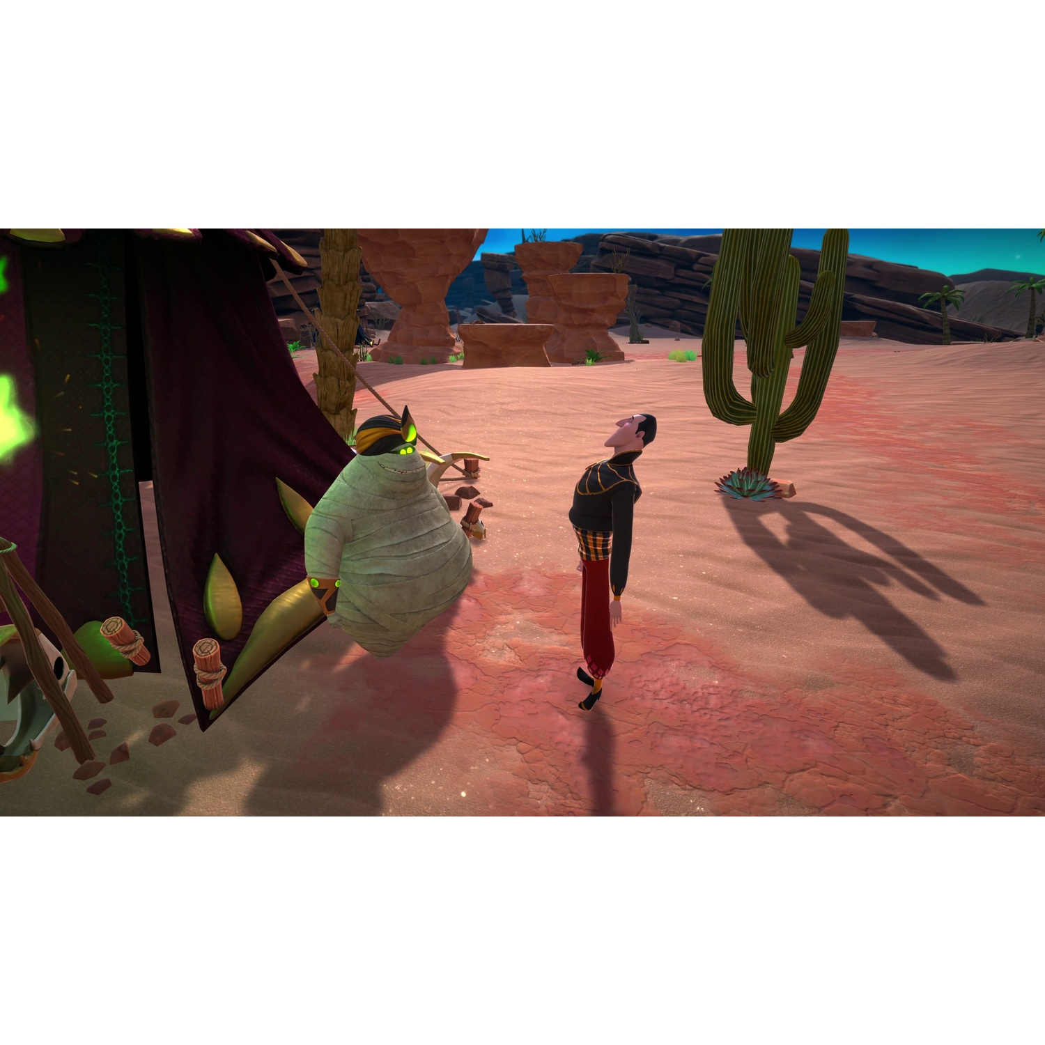 A mummy and a man stand in a desert landscape with a tent, cactus, and rocky background under a blue sky.