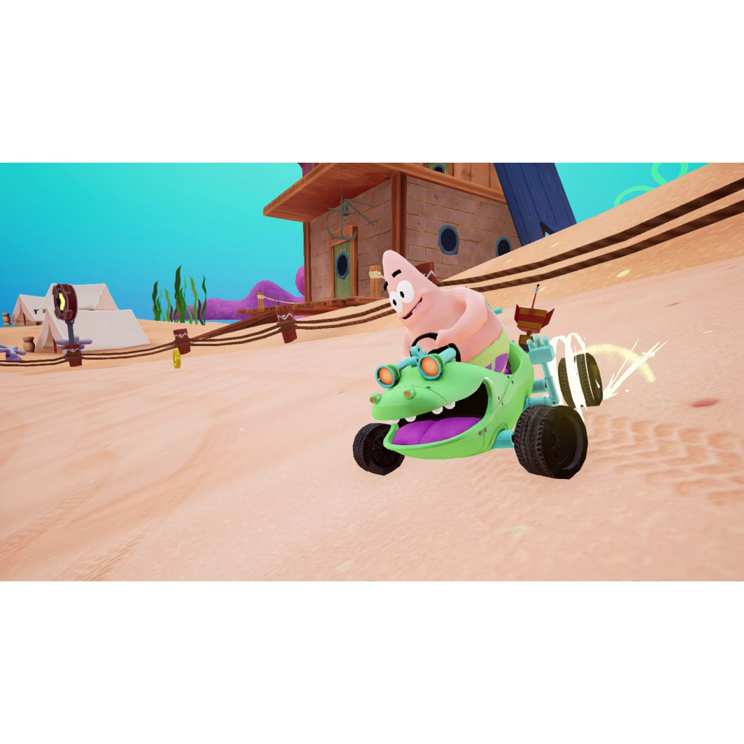 Patrick Star driving a green monster-truck kart on a sandy track with a wooden house and tents in the background.