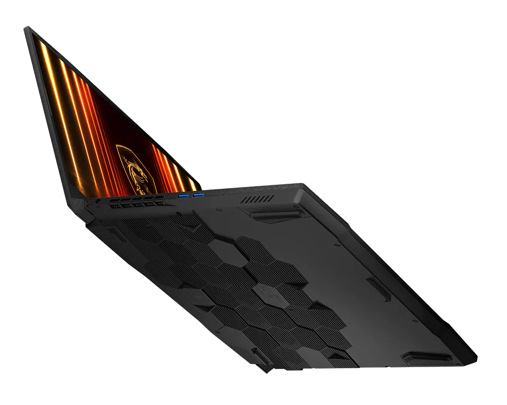 Widok od spodu czarnego laptopa z geometrycznym wzorem wentylacyjnym na czarnym tle.