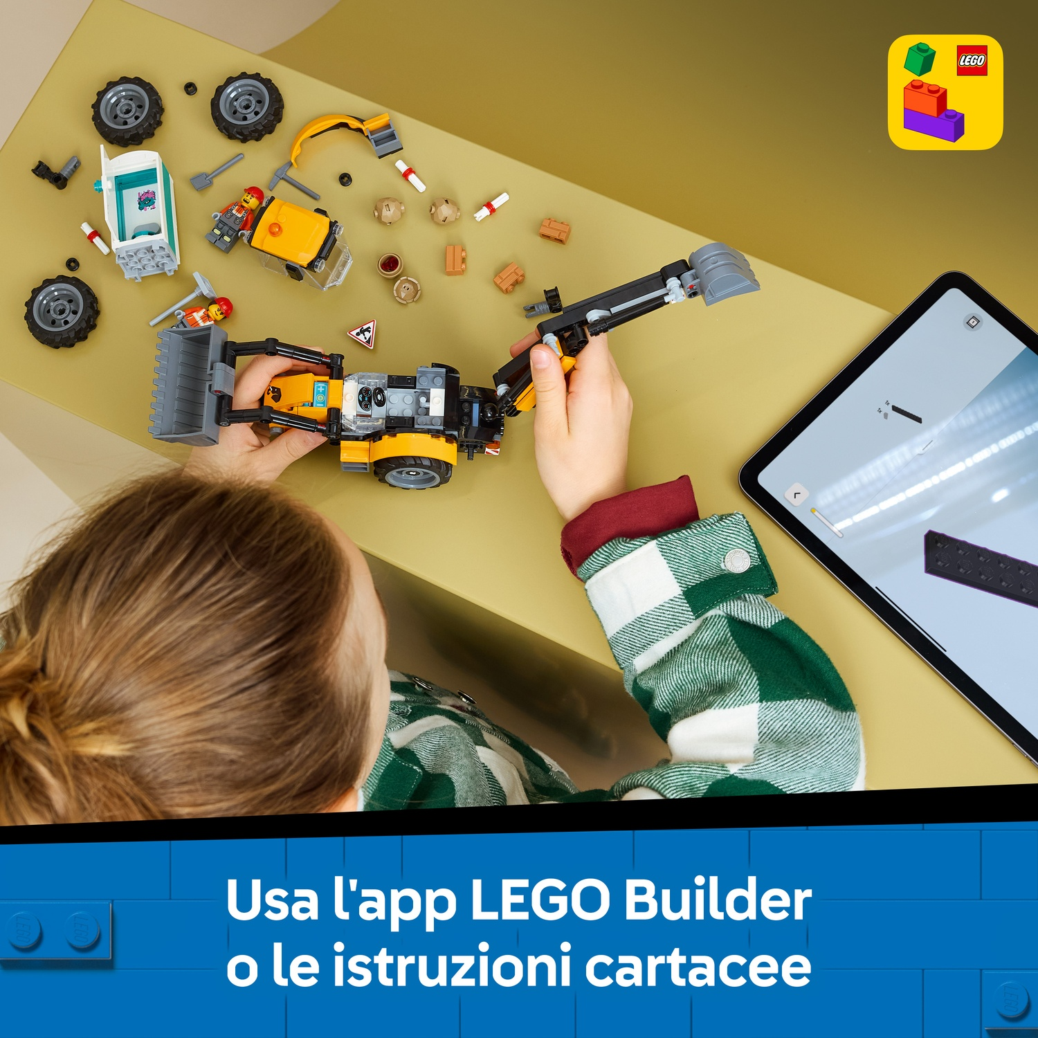 Un bambino costruisce un veicolo Lego con un tablet vicino.