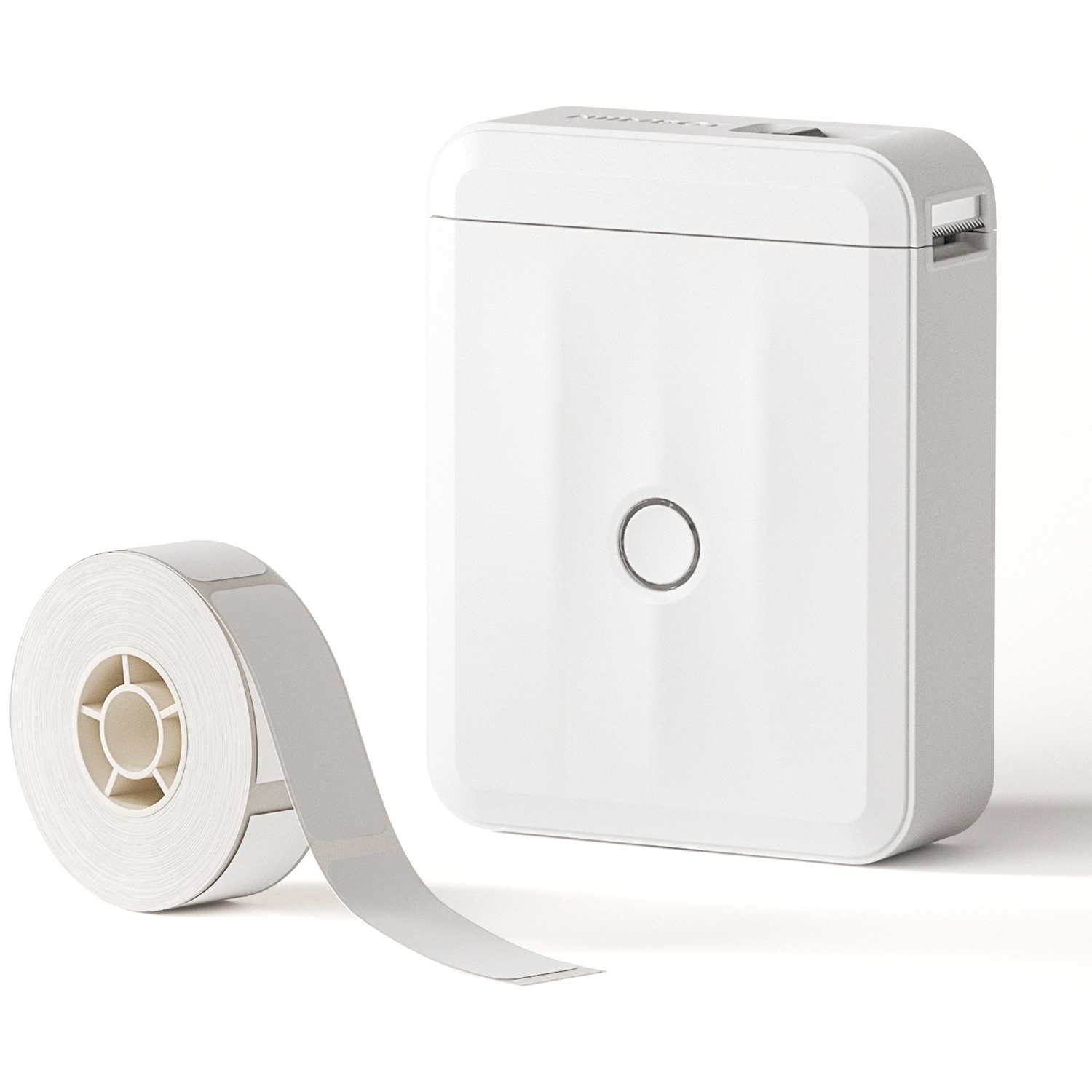A white label printer sits next to a roll of white label tape on a white background.