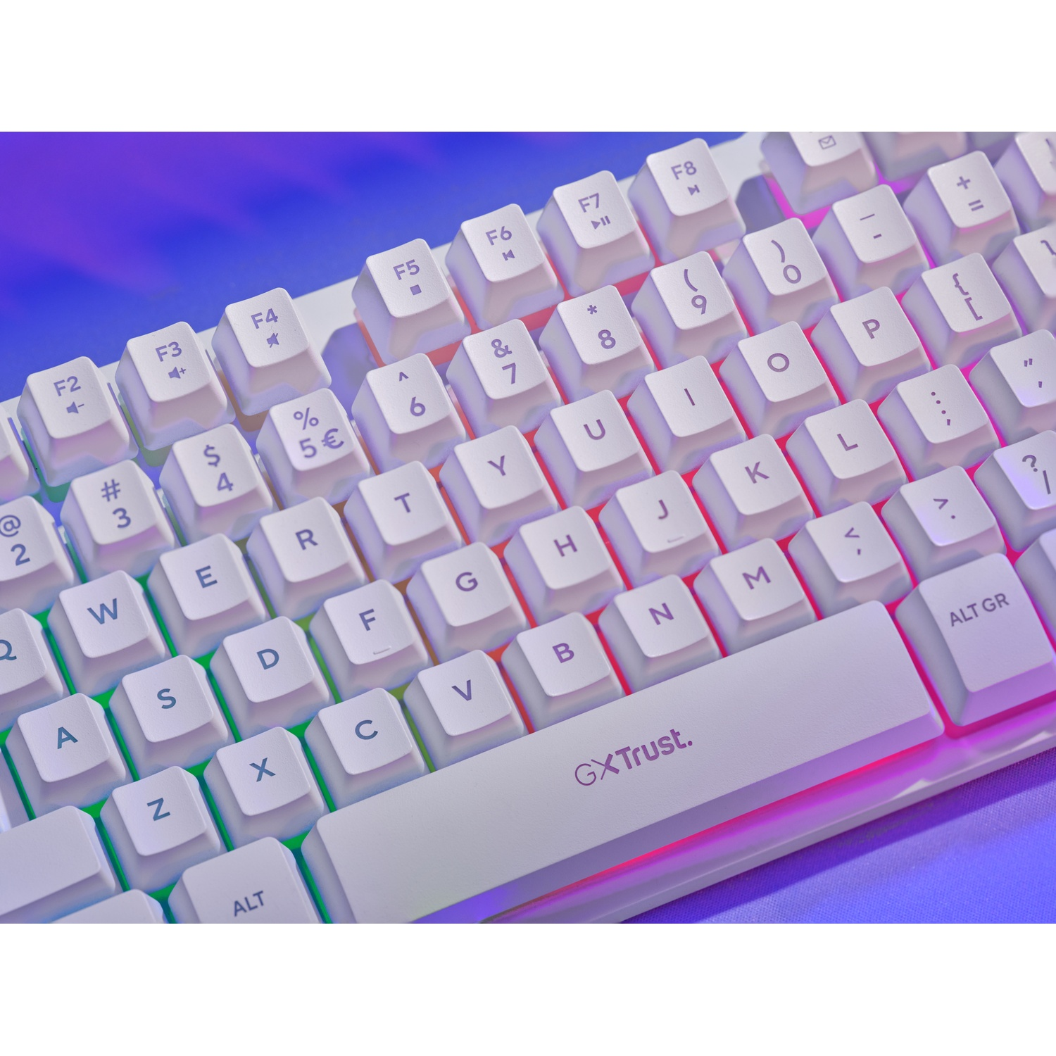 A white gaming keyboard with backlit keys and the GXTrust logo on the spacebar.
