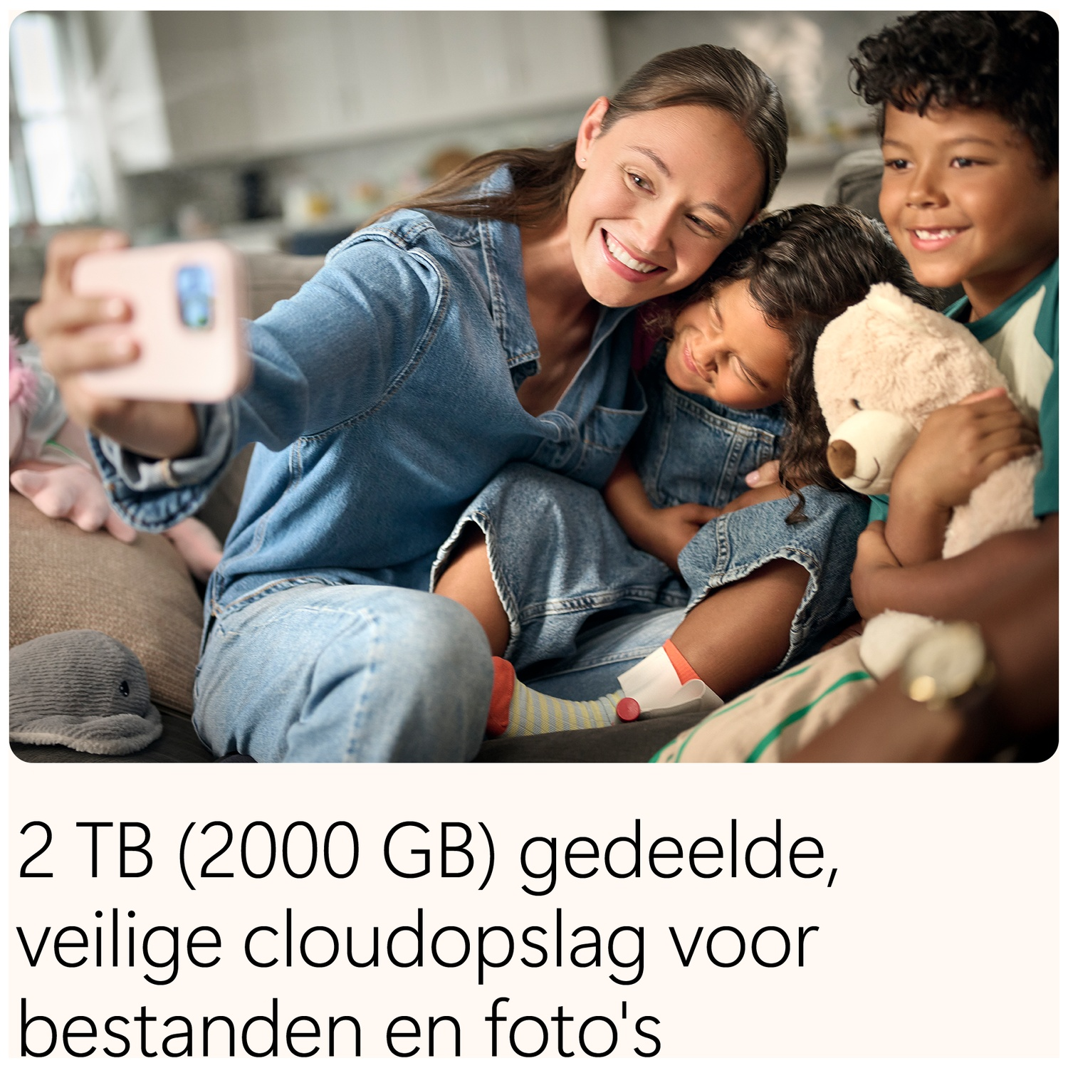 Woman taking a selfie with two children and plush toys.
