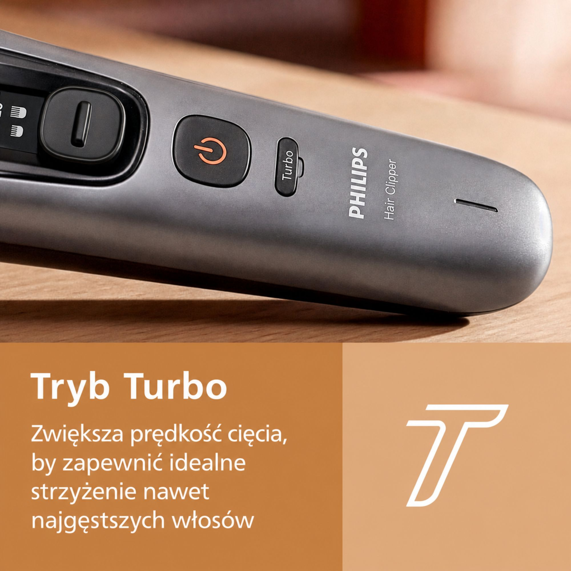 Szara maszynka do strzyżenia Philips na drewnianym blacie z przyciskami zasilania i turbo.