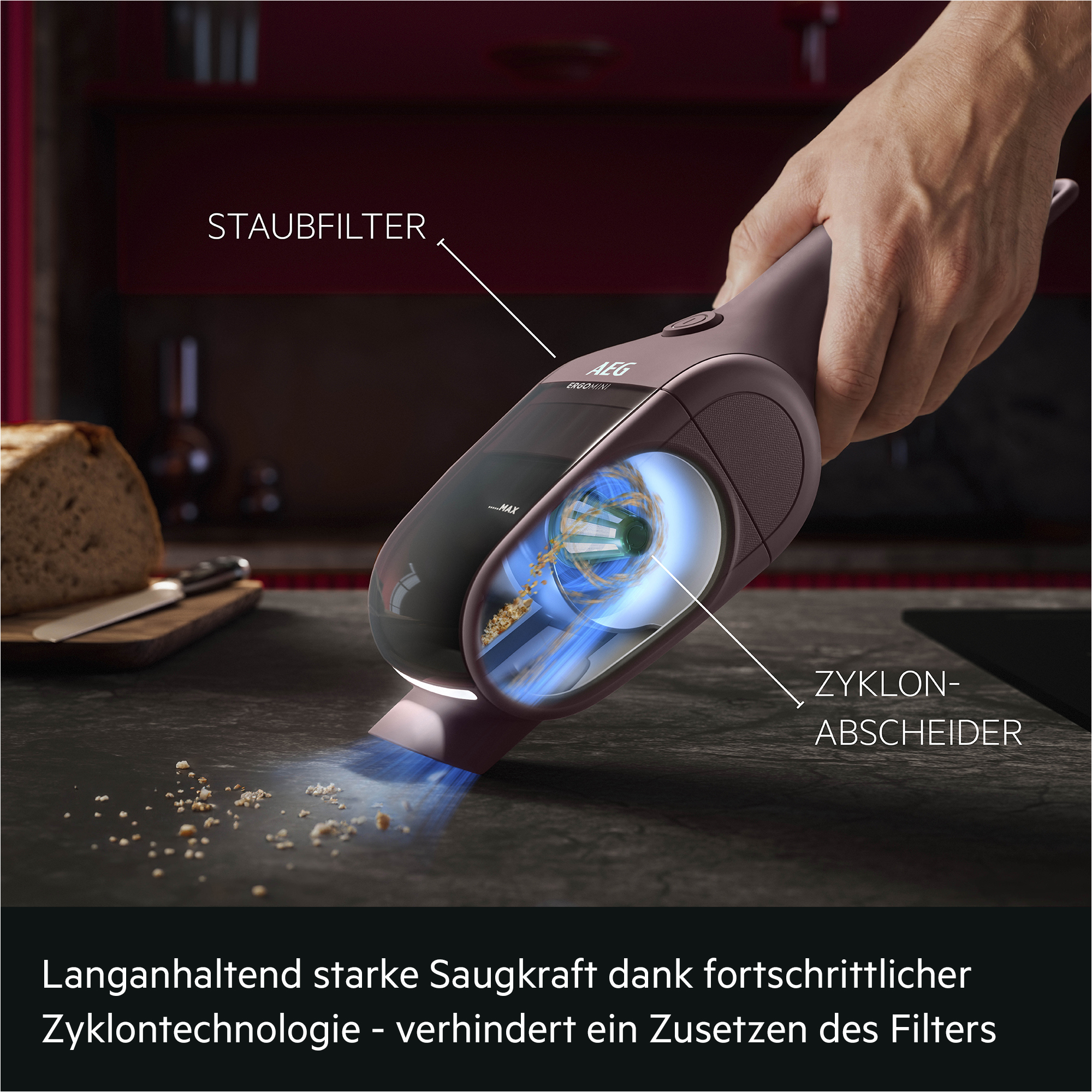 Handstaubsauger mit Zyklontechnologie saugt Krümel von der Küchenarbeitsplatte.