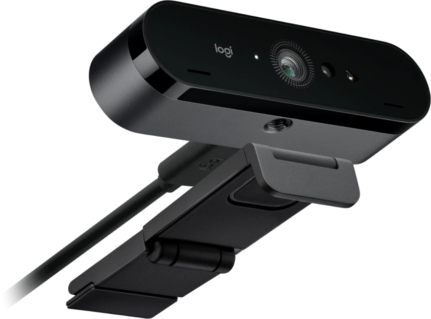Une webcam Logitech noire avec câble connecté et support réglable sur fond sombre.