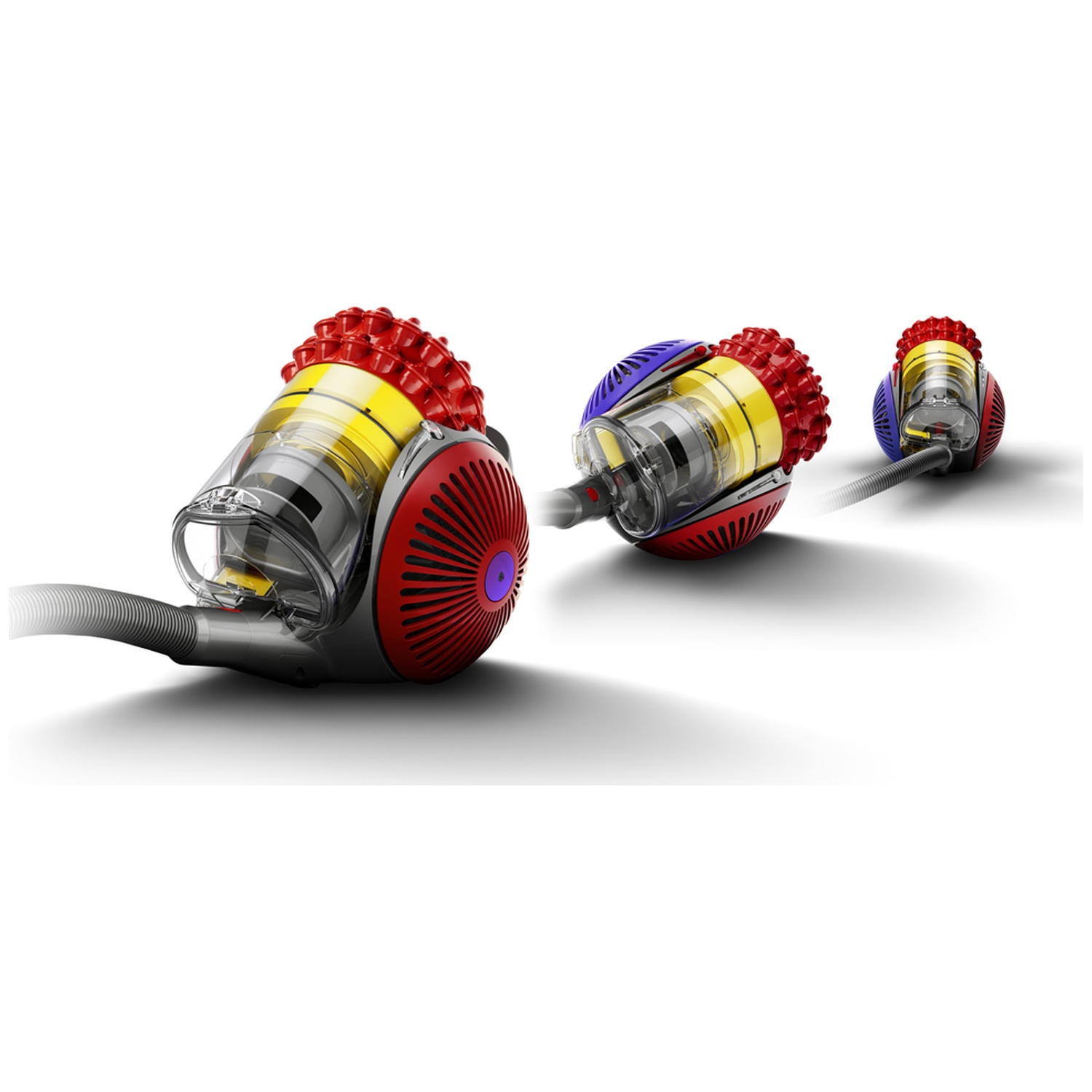 Three colorful vacuum cleaner bodies in red, yellow, and blue are lined up against a white background.