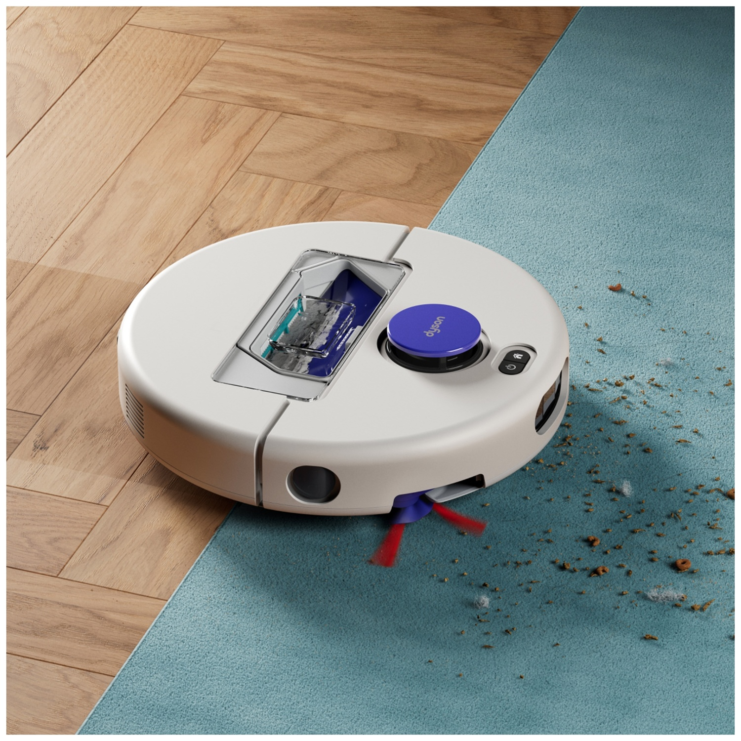 Een witte robotstofzuiger reinigt kruimels op een blauw tapijt naast een houten vloer.