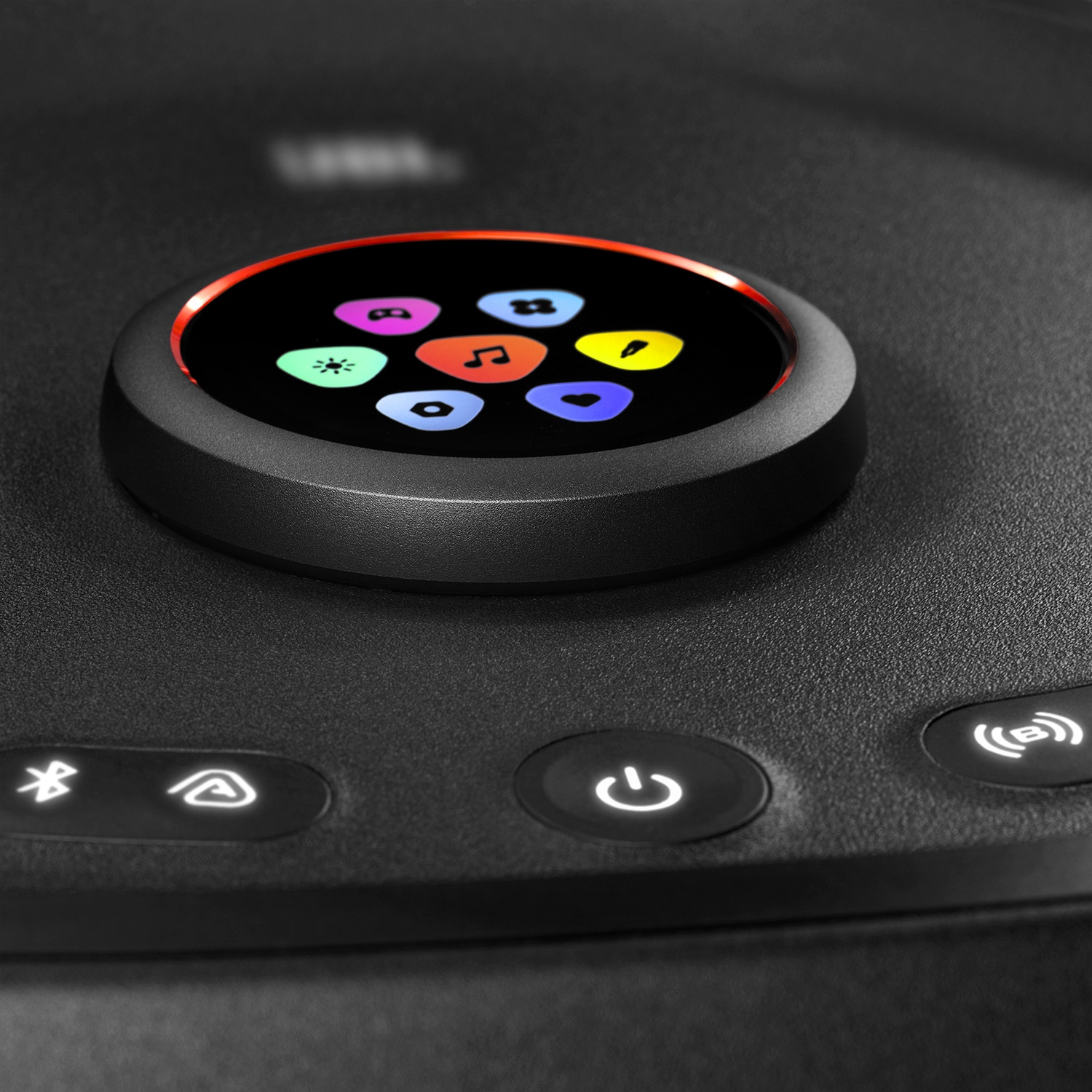 A close-up of a black device control panel with a glowing circular display surrounded by colorful touch icons.