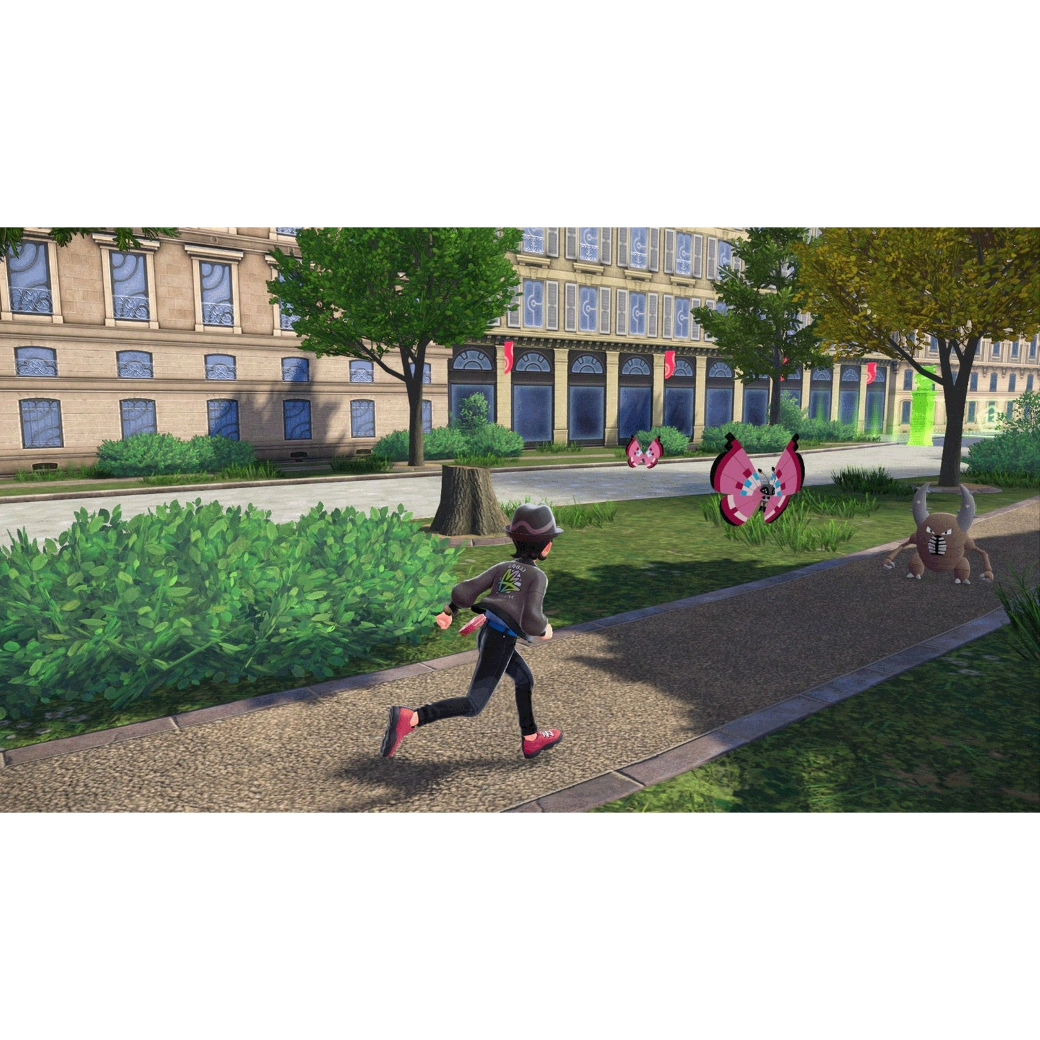 A trainer runs on a park path near pink butterflies and a horned Pokémon, with a large building in the background.