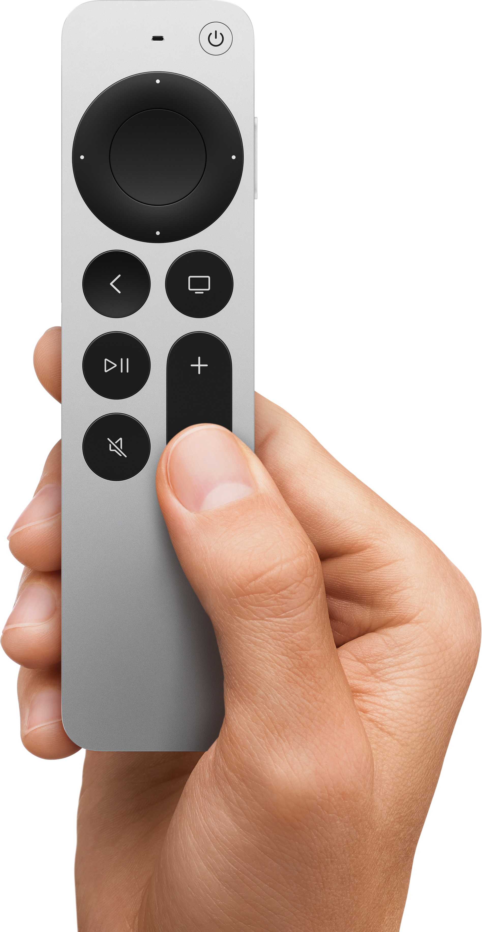 Une main tient une télécommande argentée avec des boutons noirs sur fond noir.