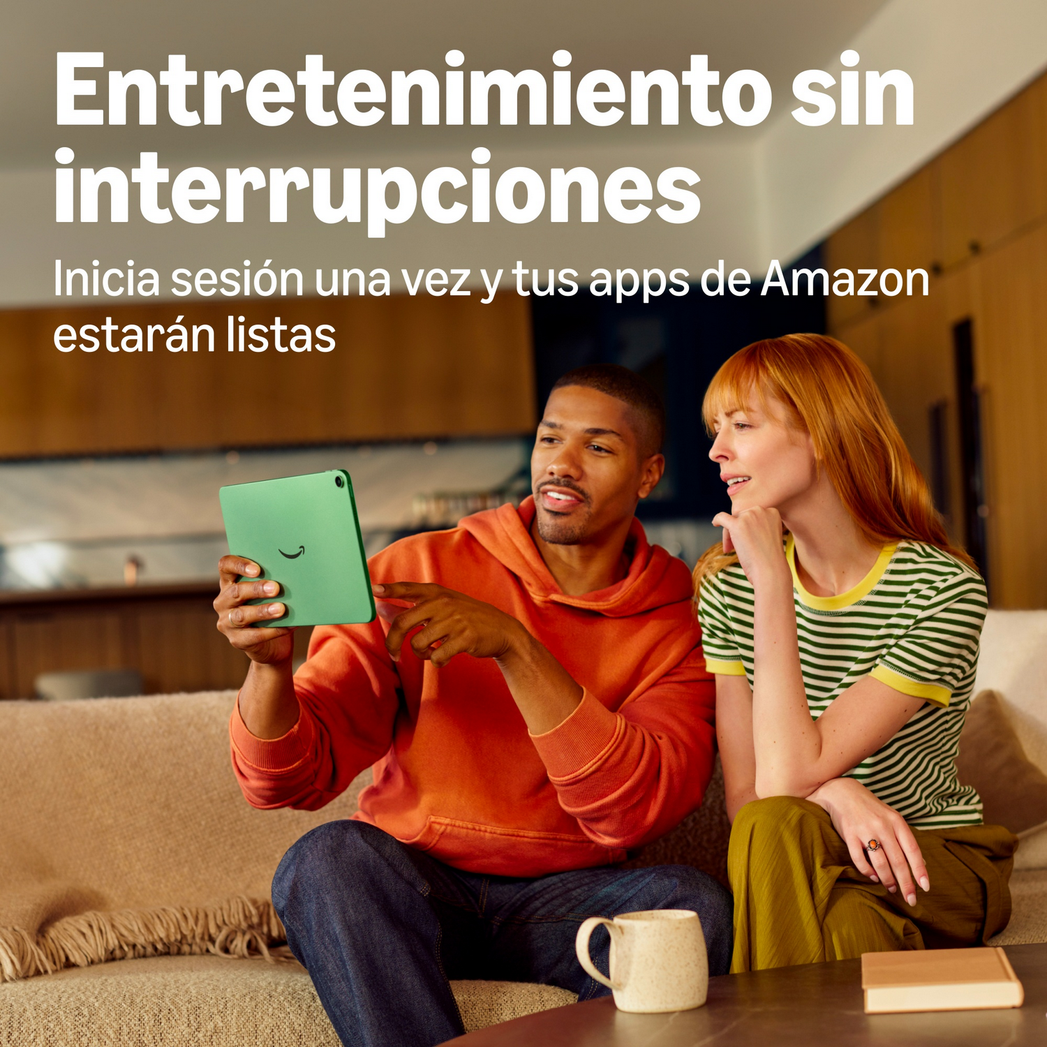 Una pareja se sienta en un sofá, mirando juntos una tableta verde en una sala.