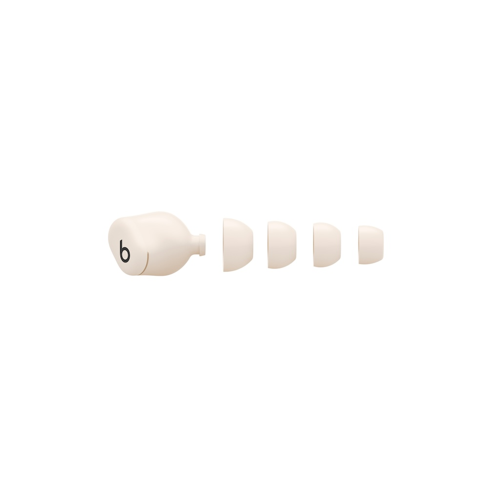 Un auricular interno beige con un logo y cuatro almohadillas de silicona en un fondo blanco.