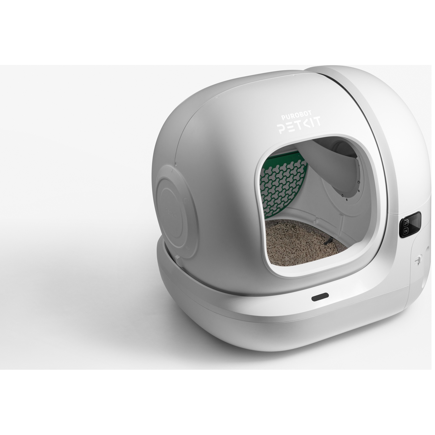 Litière pour chat automatique blanche avec litière et écran numérique sur fond blanc.