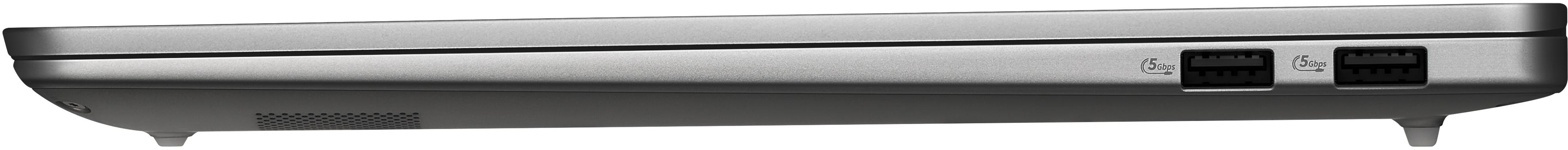 Egy szürke laptop oldalszöge két USB 5Gbps porttal és gumitalpakkal fehér háttér előtt.