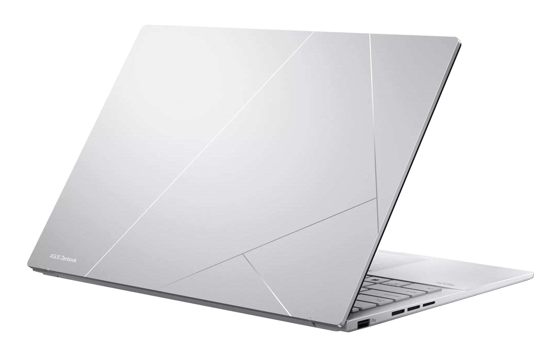 Srebrny laptop ASUS ZenBook z geometrycznym wzorem na pokrywie, na czarnym tle.