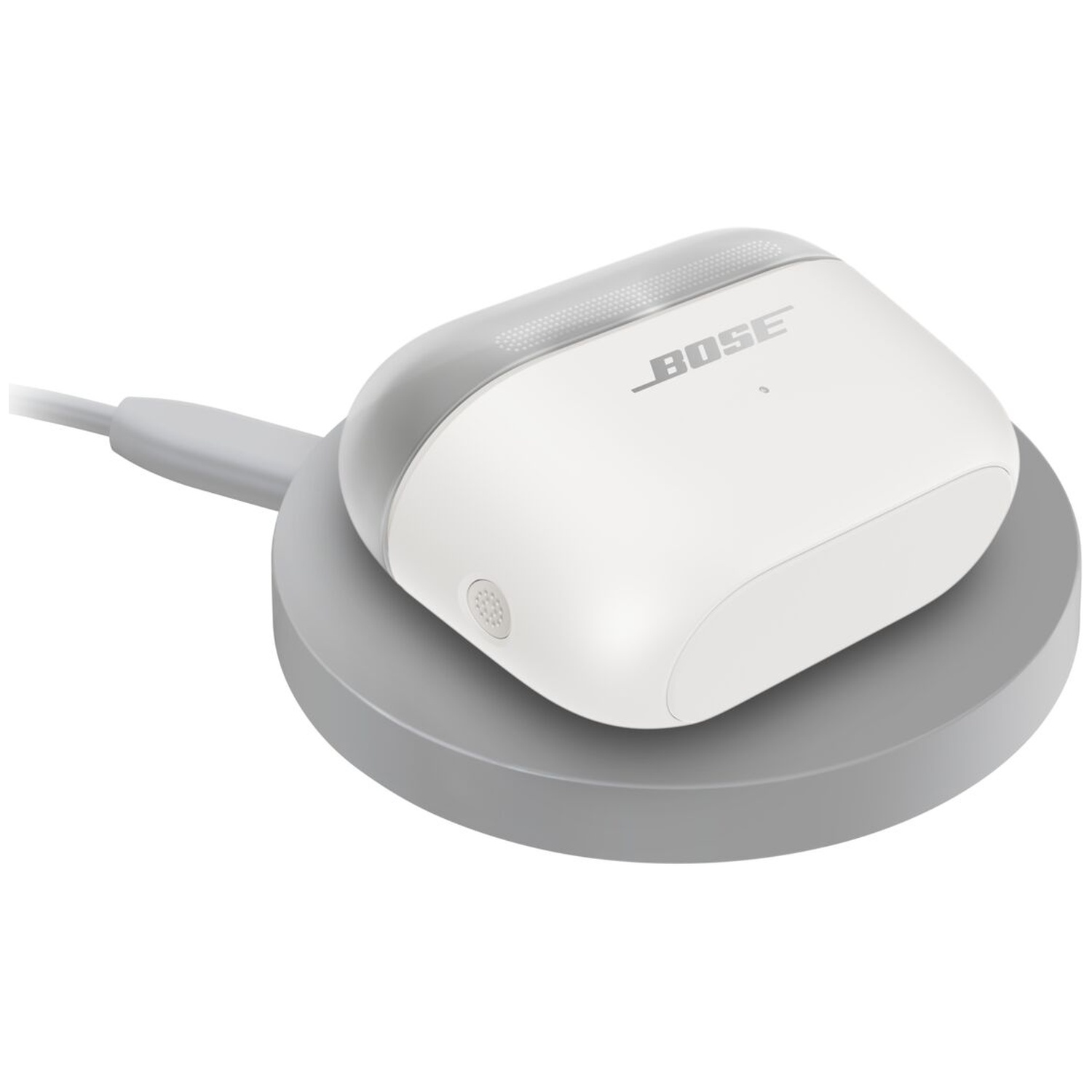 Un boîtier de charge blanc Bose avec un câble repose sur un socle de charge gris.