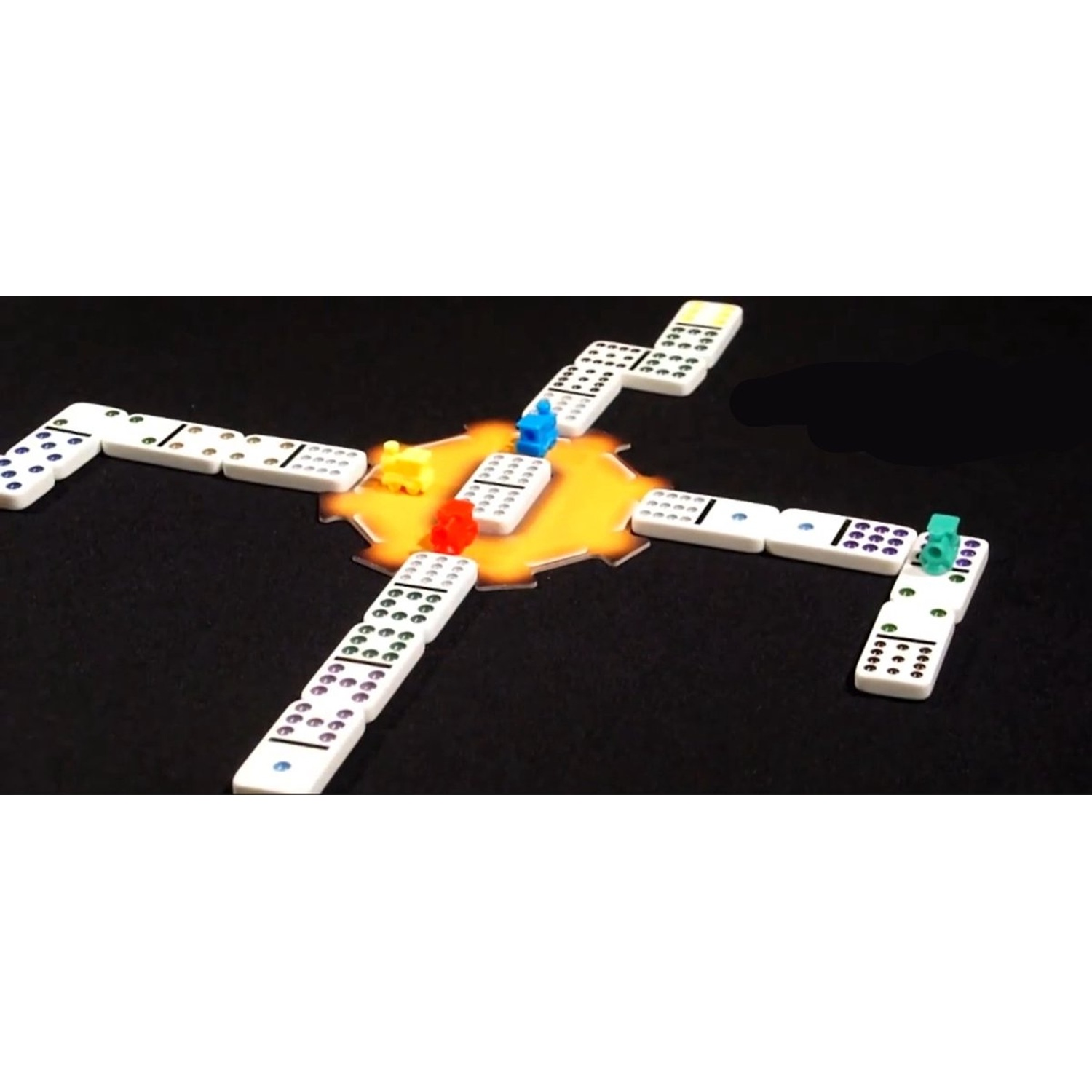 A Mexican Train domino game on a black background with colorful train markers and a yellow center.